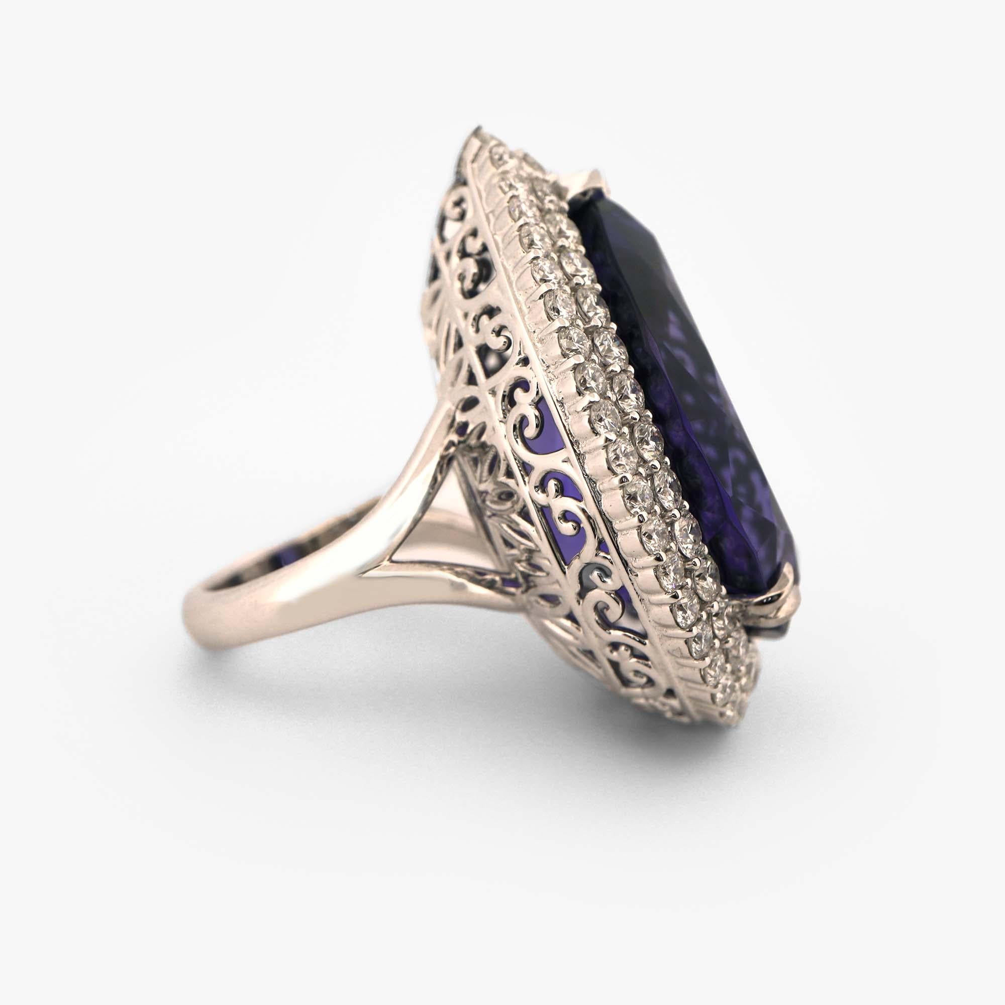 Introducing a breathtaking GIA certified cocktail ring featuring a magnificent 39.6 carat tanzanite center stone surrounded by 3.27 carats of sparkling diamonds.

Crafted with exceptional attention to detail, this exquisite ring showcases a stunning