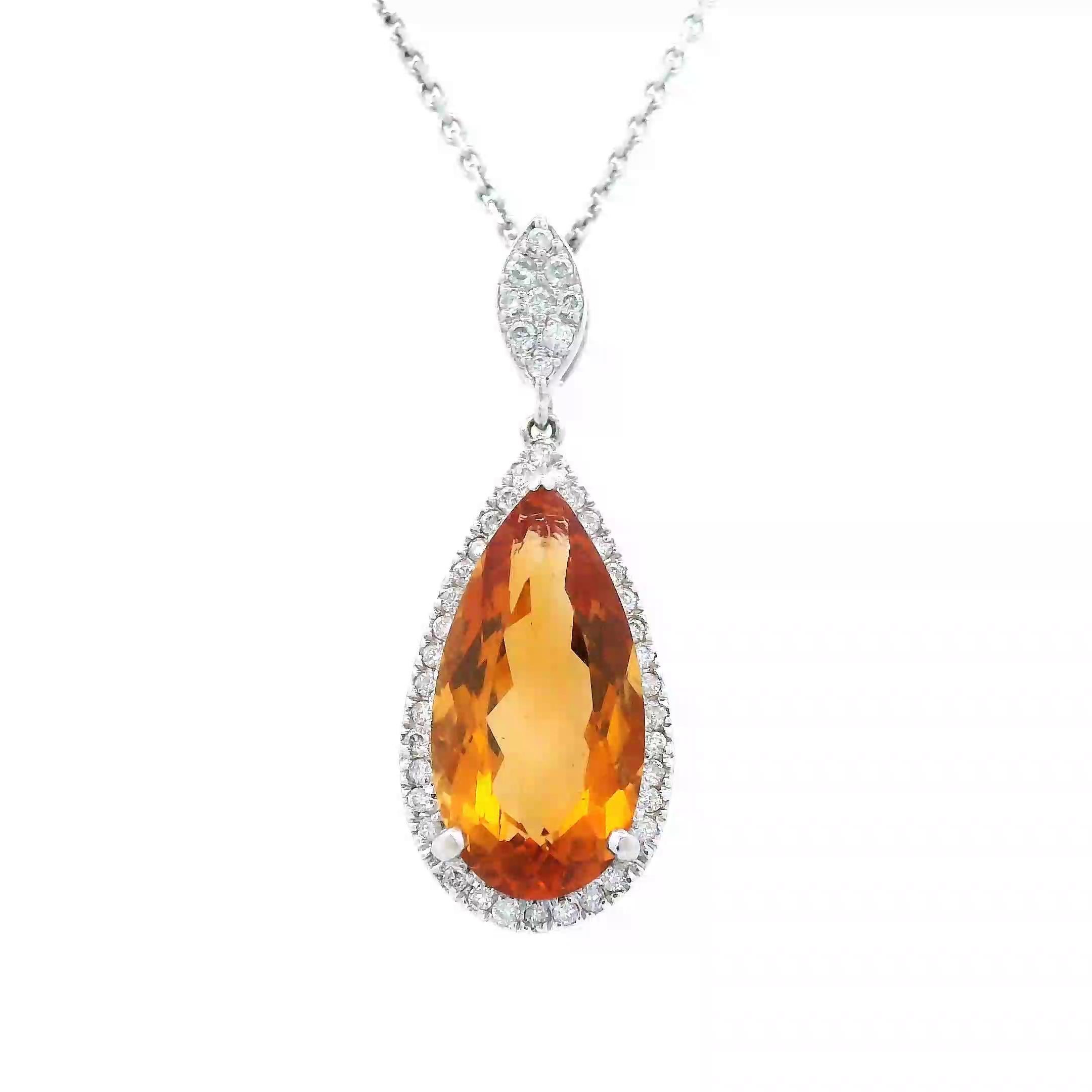 Stunning orange citrine and diamond pendant necklace.
4.19 carats total gemstone weight.
3.96 carat pear orange citrine. 45 round brilliant diamonds, 0.23 carats. Approximately G color and VS2 clarity. 14-karat white gold, 4.31 grams, 18