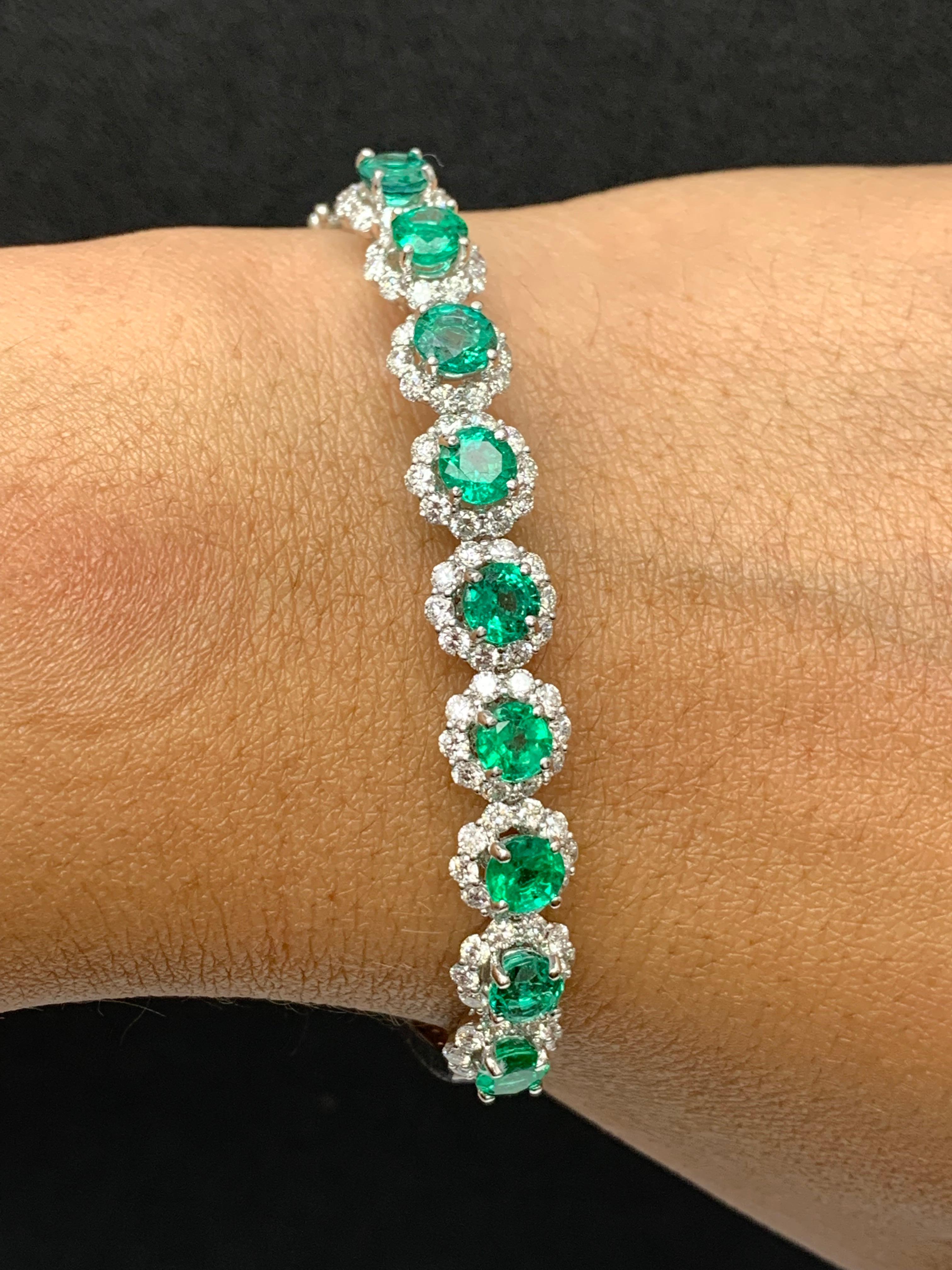 Sparkle in the spotlight with this brilliant cut emerald and diamond bangle bracelet. Features 9 brilliant-cut round emeralds weighing 3.97 carats and surrounding the emeralds are 90 diamonds weighing 2.45 carats elegantly set in an 18k white gold
