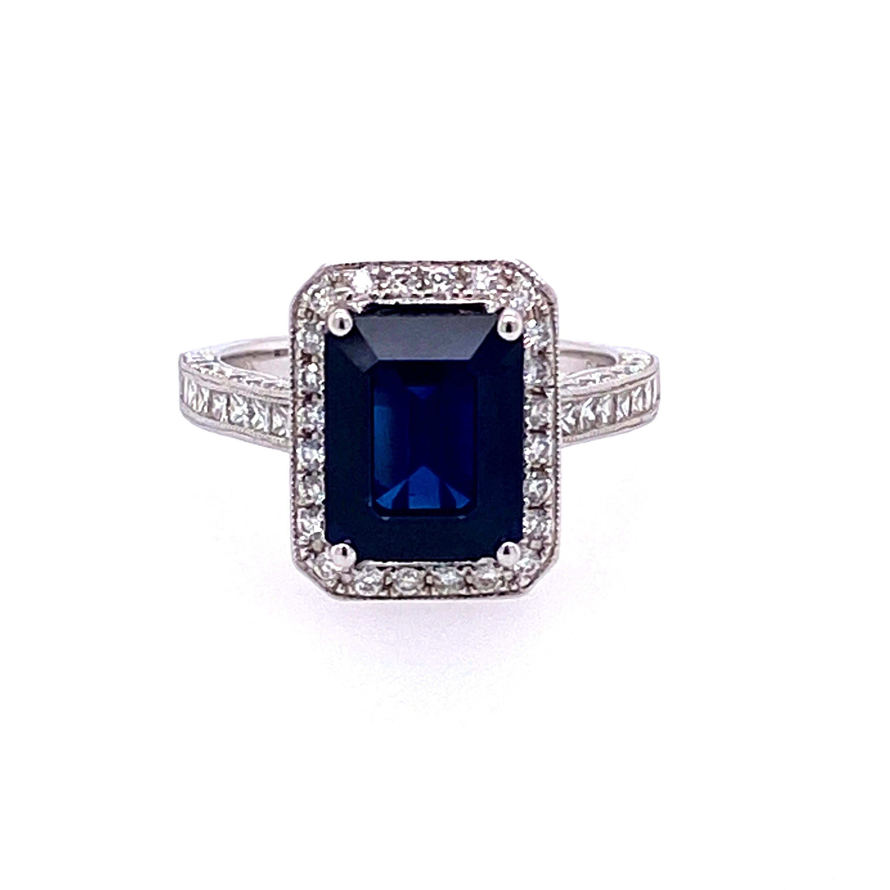 This stunning cocktail ring features a 3.97 Carat Emerald Cut Sapphire with a Diamond Halo. The Sapphire sits on a Diamond Shank and is set in 18k White Gold. Total Diamond Weight = 0.93 Carats. Ring Size is 6 1/2. 