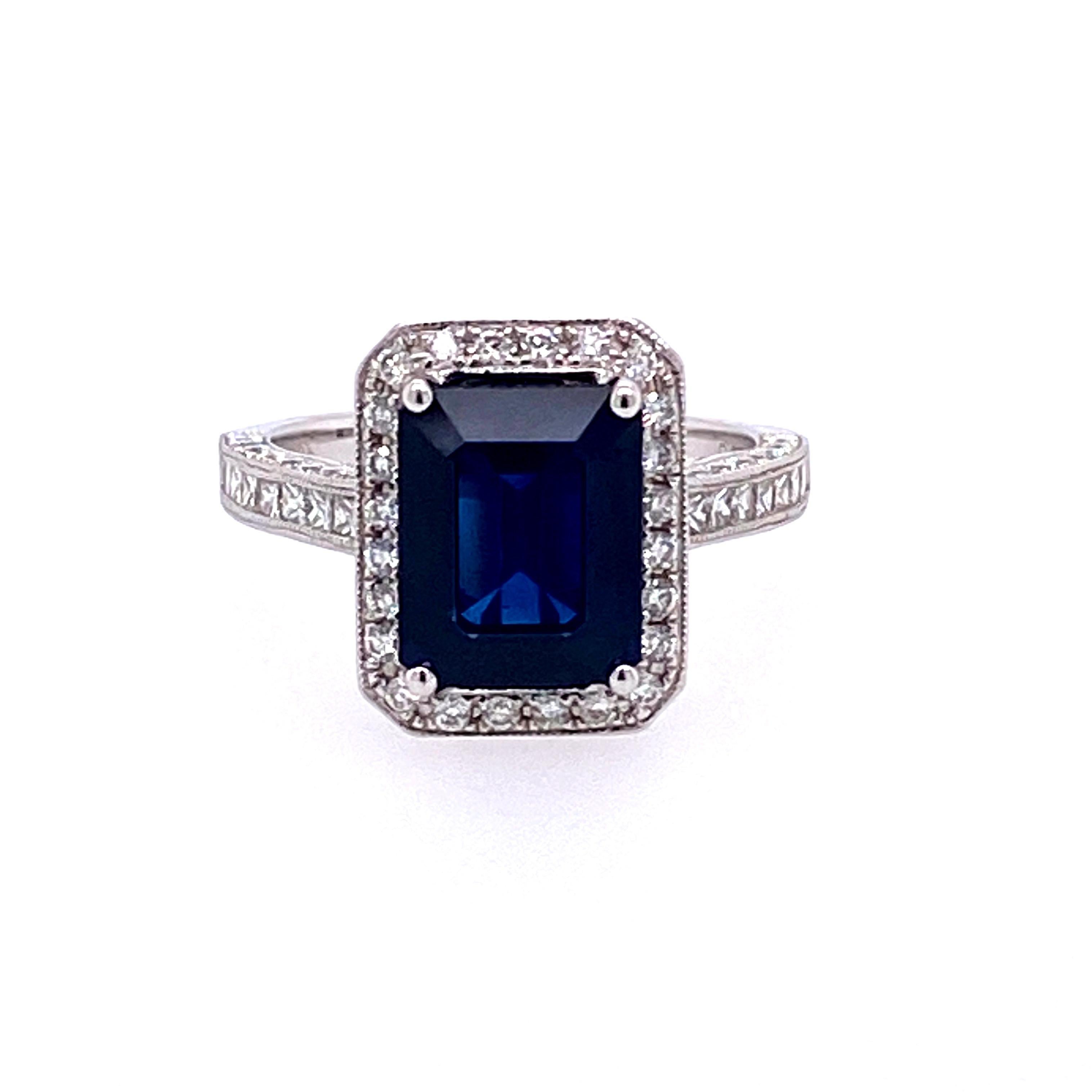 This stunning cocktail ring features a 3.97 Carat Emerald Cut Sapphire with a Diamond Halo. The Sapphire sits on a Diamond Shank and is set in 18k White Gold. 

Total Diamond Weight = 0.93 Carats. Ring Size is 6 1/2. 