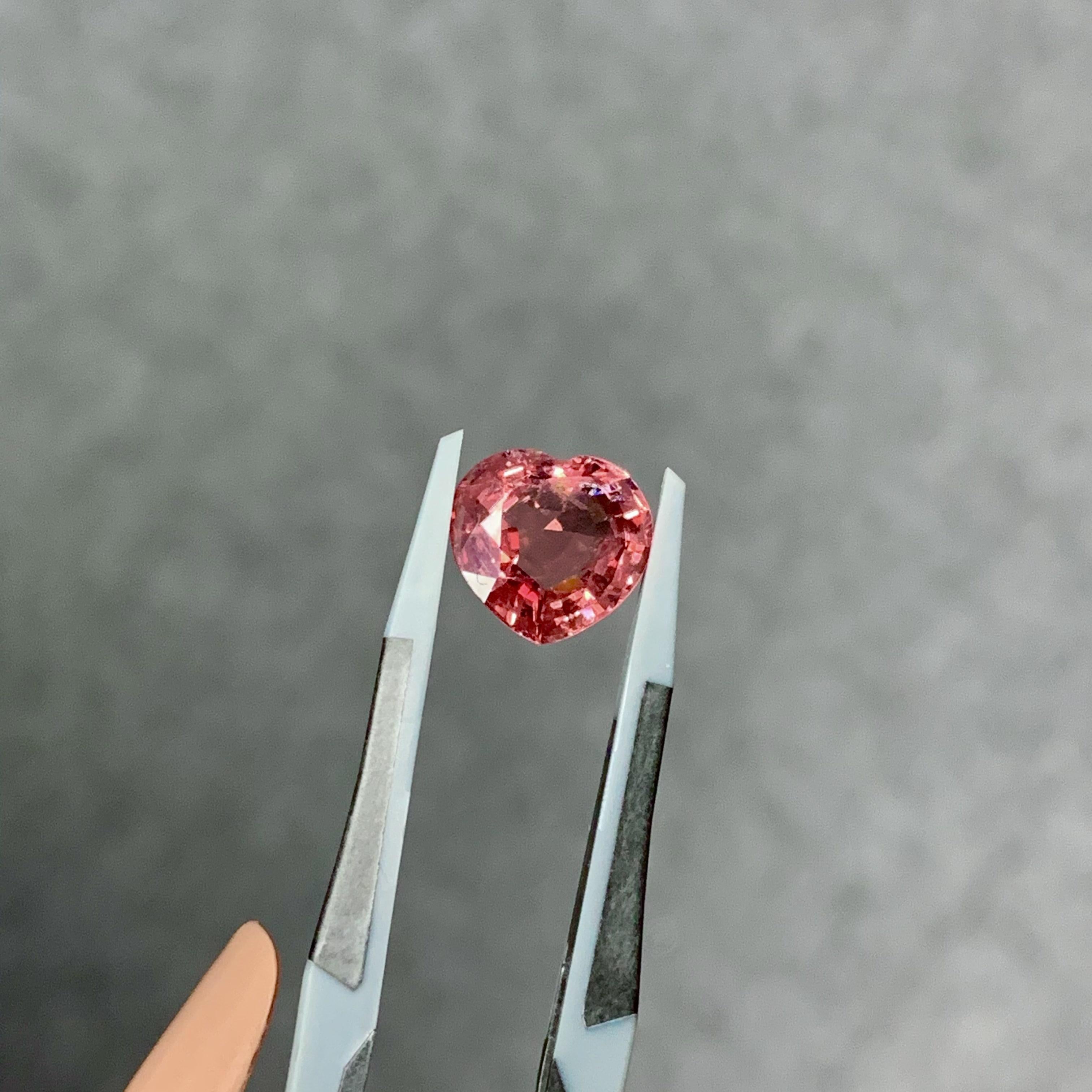A lovely, stunning 3.97 Carat Spinel stone that has a beautiful orangish and pink tone. The spinel piece is cut perfectly into a heart shape.

The spinel originates from Tanzania and is a 100% natural. It has not undergone any form of heating or