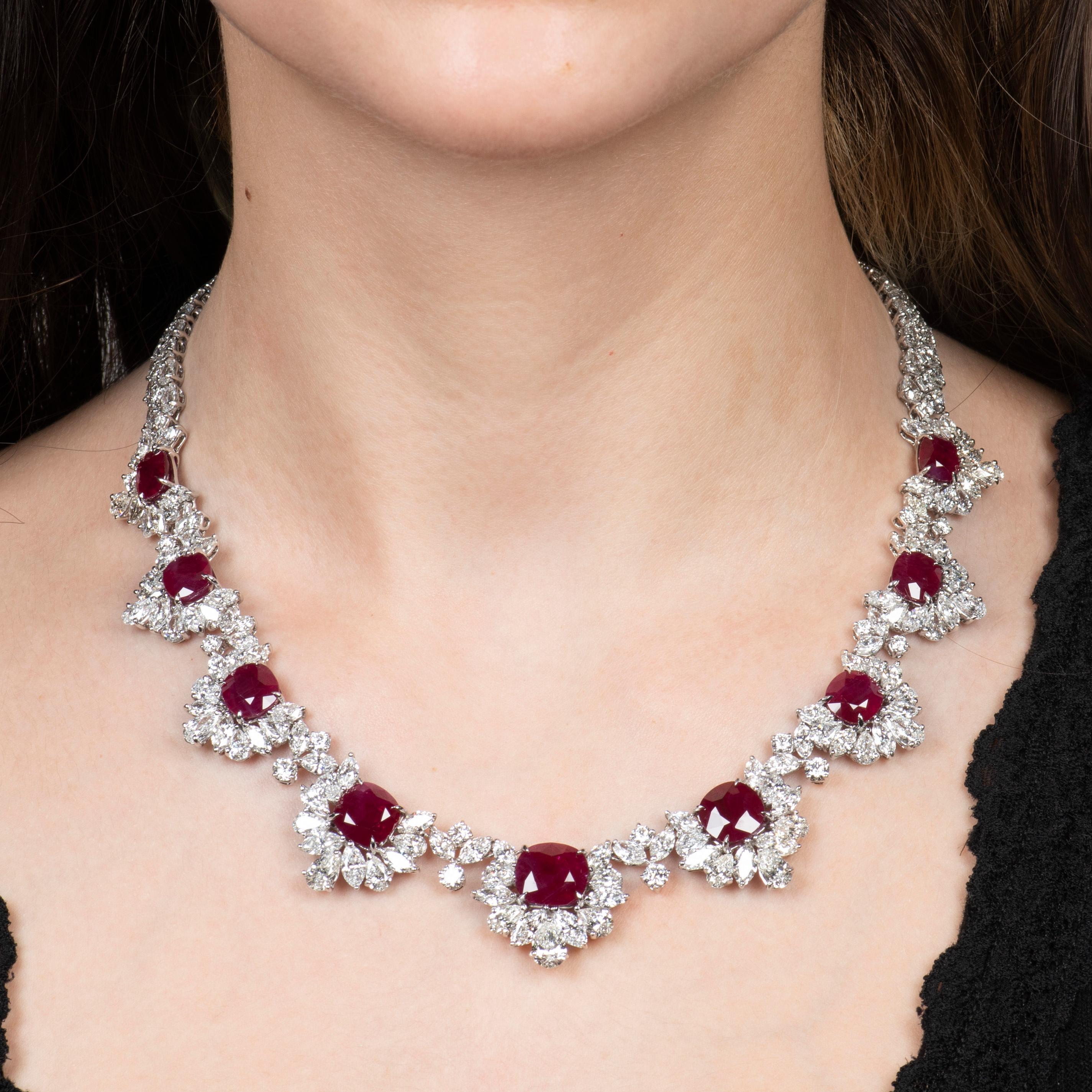 This luxurious necklace is one of the most exquisite pieces we have ever laid eyes on. With its 39.74ct total weight in pigeon's blood red, natural, cushion cut Burma rubies and its 49.56ct total weight in diamonds, surrounding the rubies and