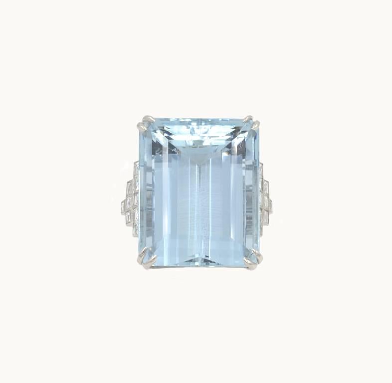 A large and very chic aquamarine and diamond platinum cocktail ring from circa the 2000s.  This beautiful ring features an emerald cut 39.78 carat aquamarine with 18 square cut diamonds on the sides, which total approximately 0.80 carats.