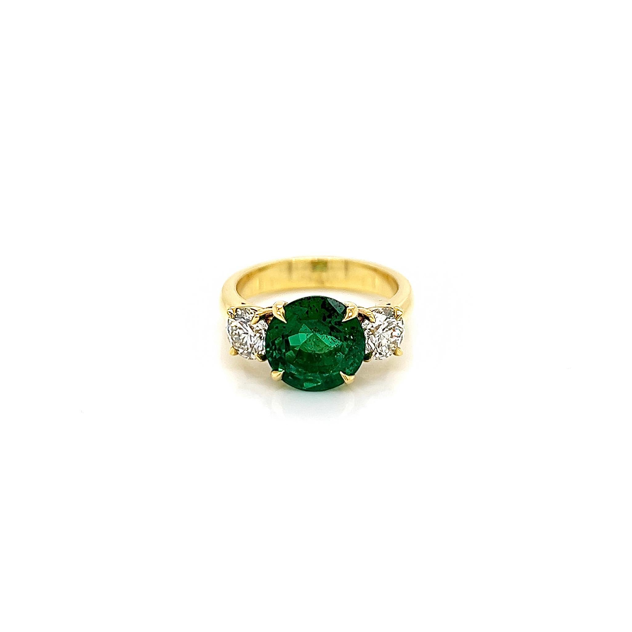 3.97 Total Carat Emerald and Diamond Three Stone Ladies Ring, GIA Certified.

-Metal Type: 18K Yellow Gold
-2.95 Carat Round Cut Natural Colombian Beryl Emerald, GIA Certified 
-Emerald Color: Green
-Emerald Measurements: 9.58 x 9.43 x 5.80 mm
-1.02