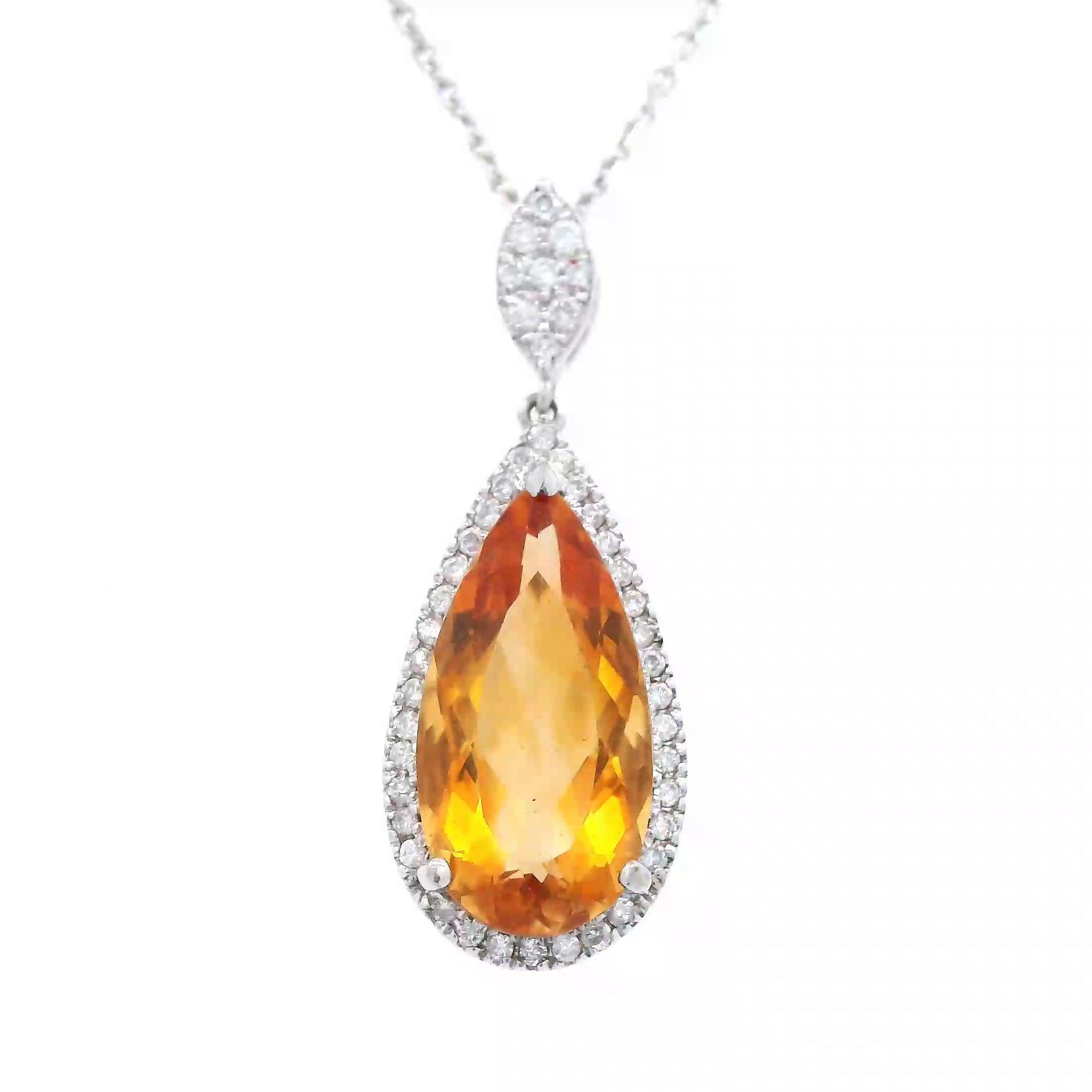 Stunning orange citrine and diamond pendant necklace.
4.21 carats total gemstone weight.
3.97 carat pear orange citrine. 45 round brilliant diamonds, 0.24 carats. Approximately G color and VS2 clarity. 14-karat white gold, 4.31 grams, 18