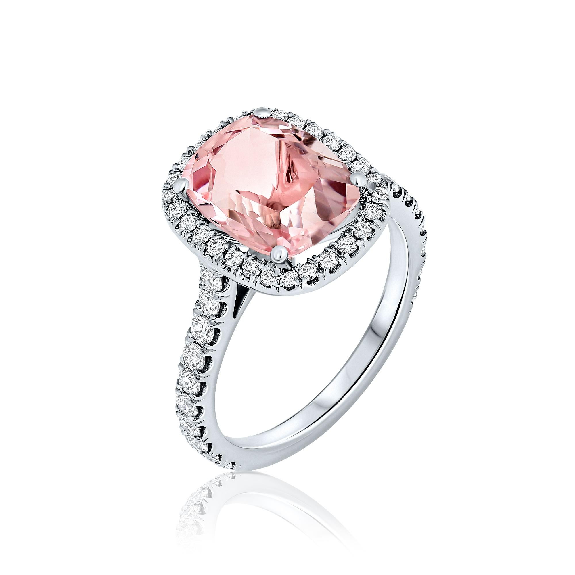 Cocktail ring style showcasing a 3.36 carat cushion cut Pink Morganite. The classic design brings out the beauty of the center stone with the surrounding 48 round brilliant diamonds, set in a polished 18k white gold mounting. A truly meaningful