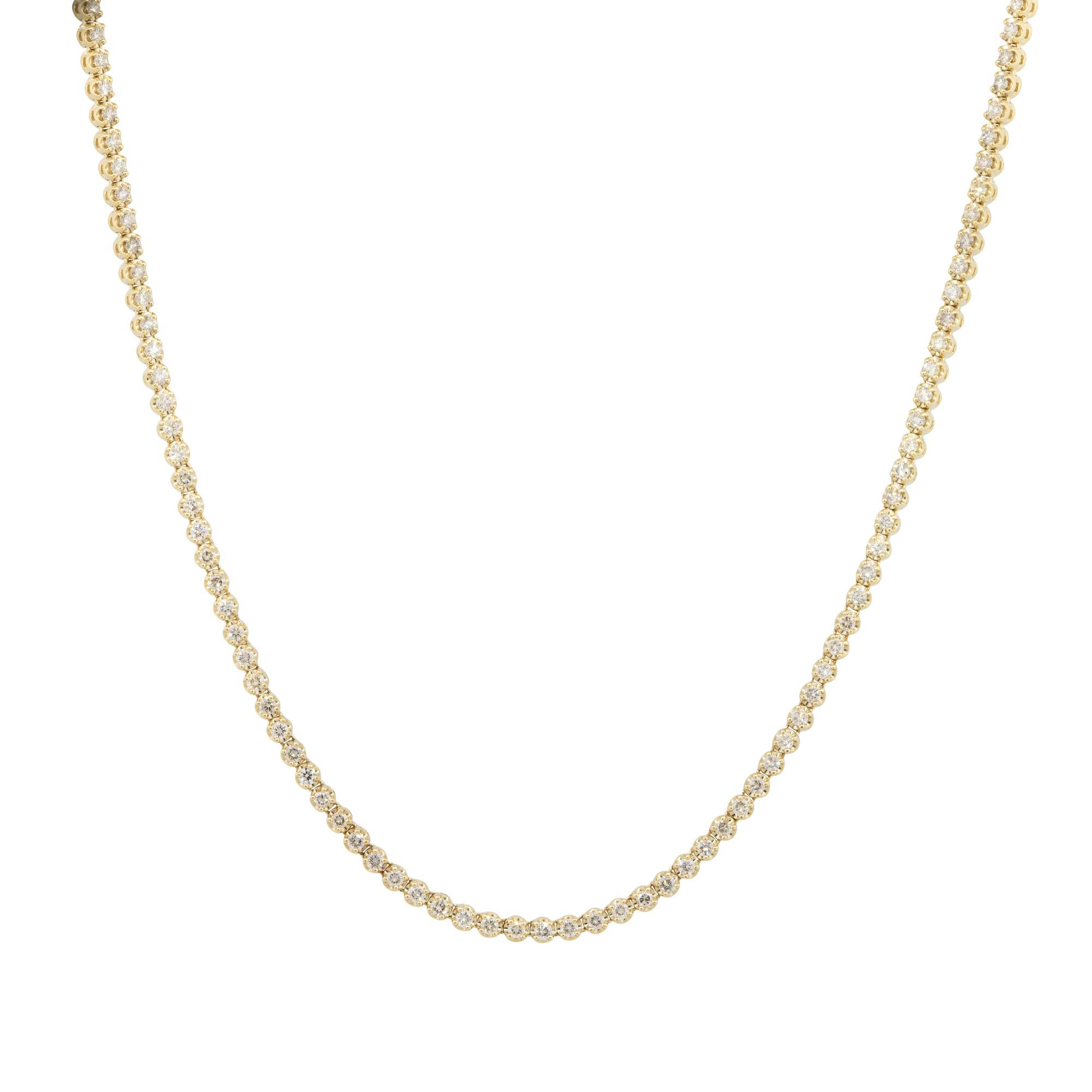 This tennis necklace showcases 3.98 carats of round brilliant diamonds all set in 14 karat yellow gold. The diamonds are near colorless, approximately a G/H in color, and are approximately VS/SI in clarity. This necklace is a staple item for any