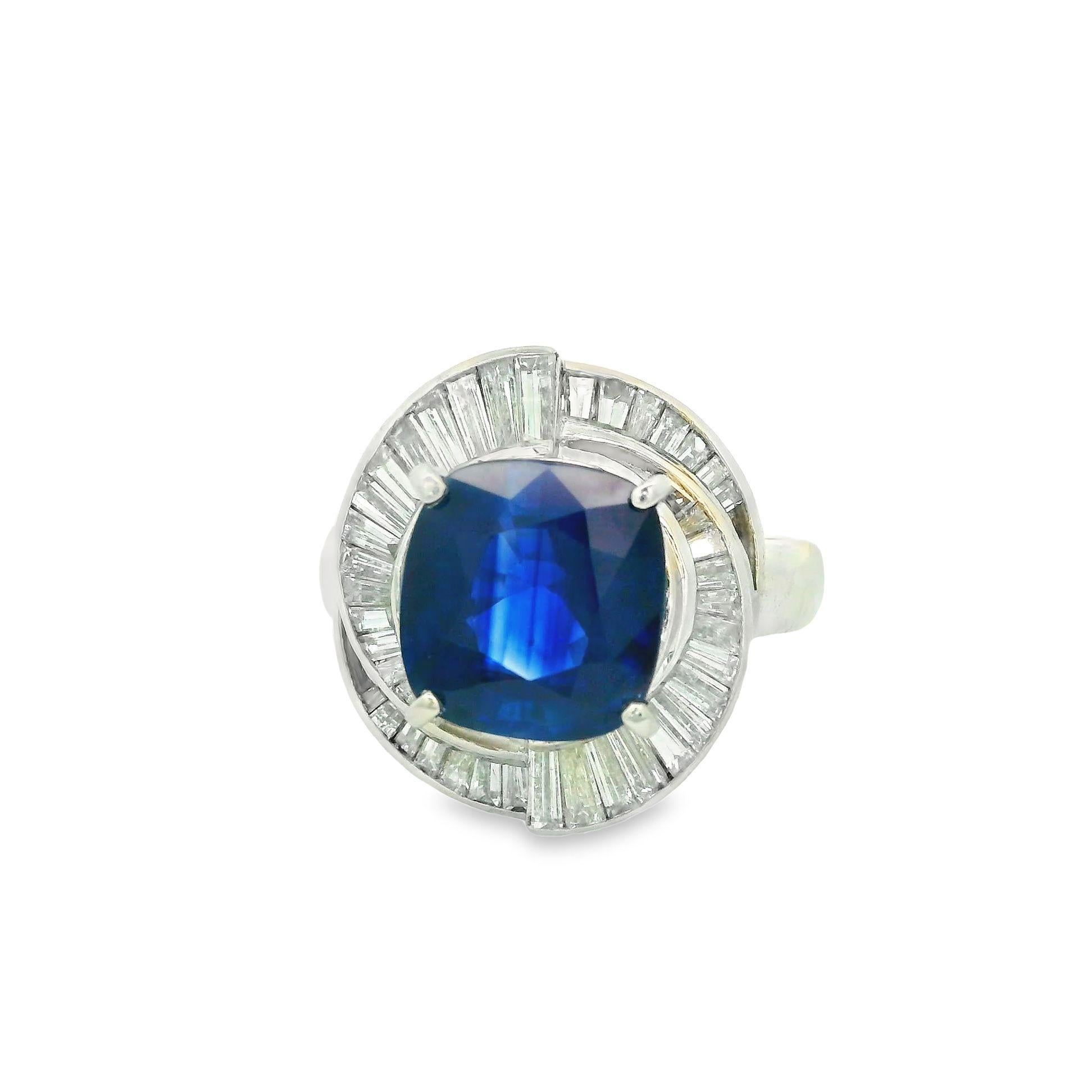 A superb richly colored sapphire takes center stage of this platinum diamond ring. The sapphire weighs just under 4 carats, (3.98), and has a rich vivid blue color known in the trade as “royal blue” for the finest of sapphires. The GRS lab in