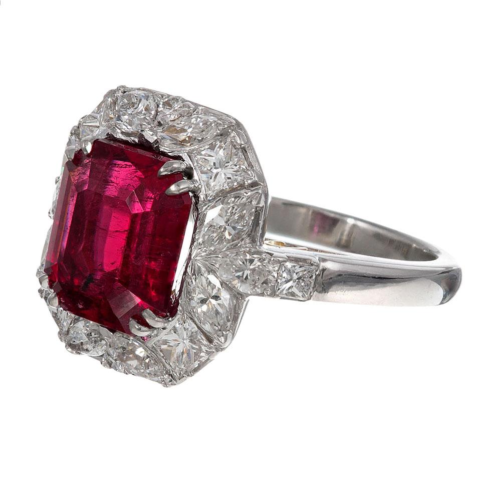 The sculpted platinum mounting is substantial in design and substance, celebrating the major stone in all of its glory. The rubellite center stone exhibits strong and intense color and is framed in an elaborate halo of round and marquis diamonds