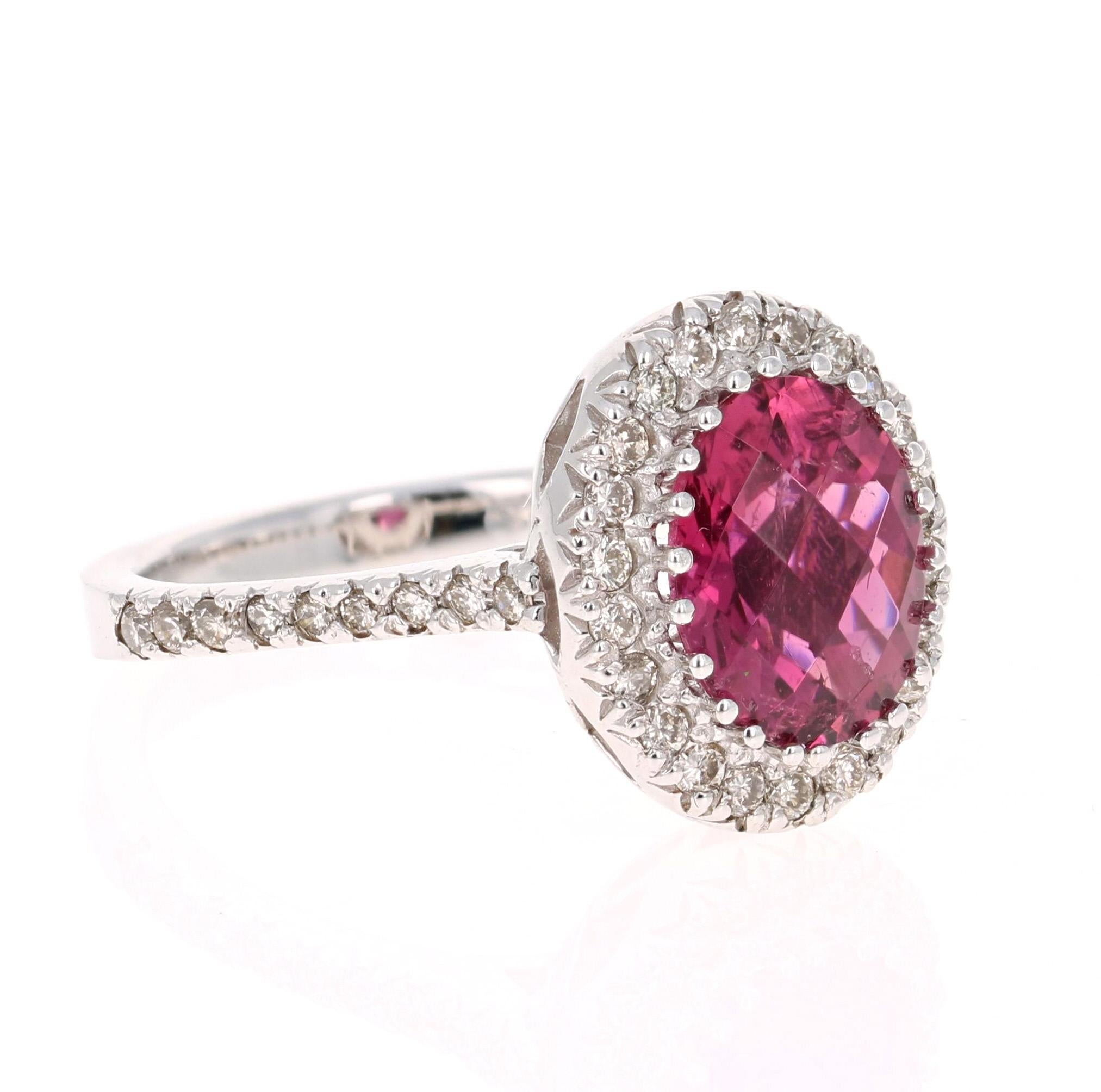 This ring has an Oval Checkered Cut Pink Tourmaline that weighs 2.46 Carats. Floating around the tourmaline are 40 Round Cut Diamonds weighing 0.50 Carats. Clarity: VS, Color: H. 
The total carat weight of the ring is 2.96 Carats. 

The tourmaline