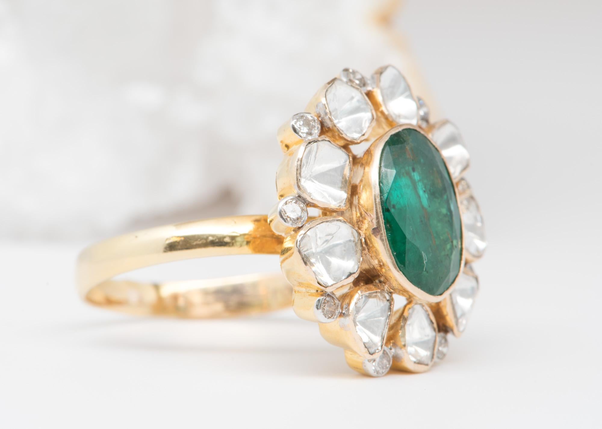 ♥  Solid 14K yellow gold ring set with an oval-shaped emerald in the center, flanked by halo of diamond slices and brilliant cut diamonds 
♥  The diamond slices have a foil-back finish to give it more brilliance and the illusion that these are