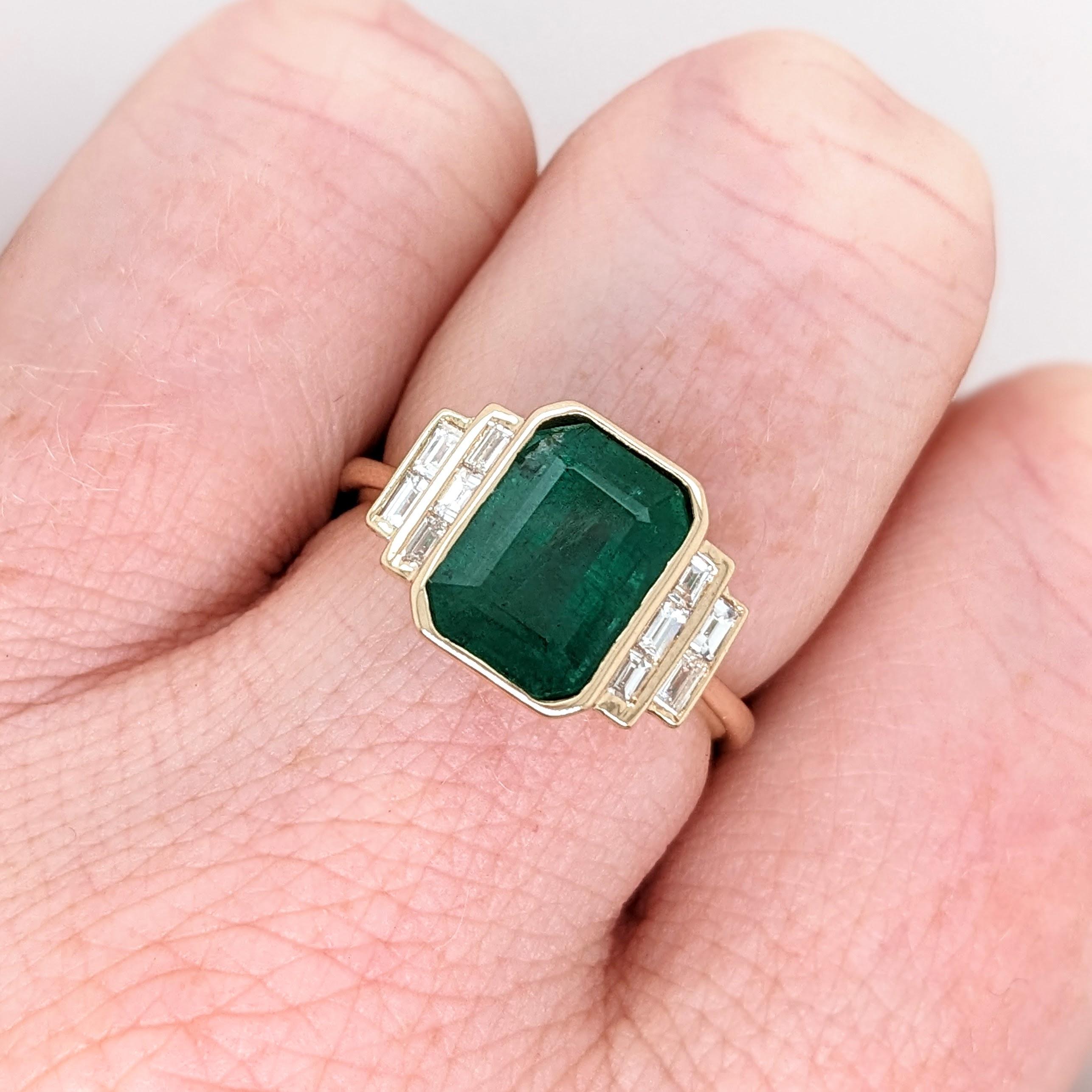 This beautiful dainty ring features a vibrant deep green emerald in 14k yellow gold with baguette diamond accents. A minimalist ring design perfect for an eye catching engagement or anniversary. This ring also makes a beautiful birthstone ring for