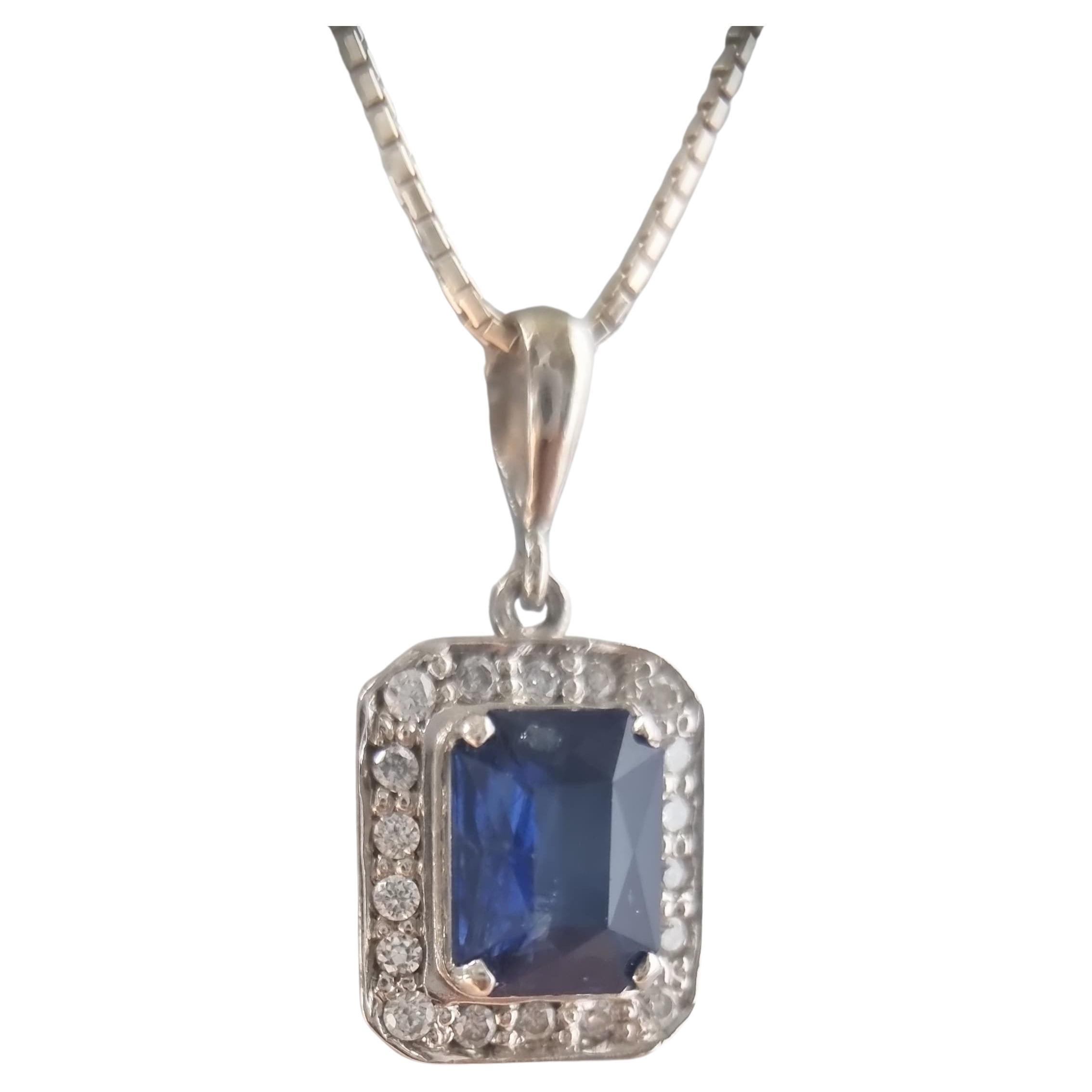 Experience the subtle elegance of our 14.3x12.2mm Platinum-Coated Sterling Silver Necklace, showcasing a captivating 3.5-carat blue sapphire measuring 9.3x7.3mm in a sleek prong setting. Thoughtfully cut in a rectangular emerald shape, the gemstone