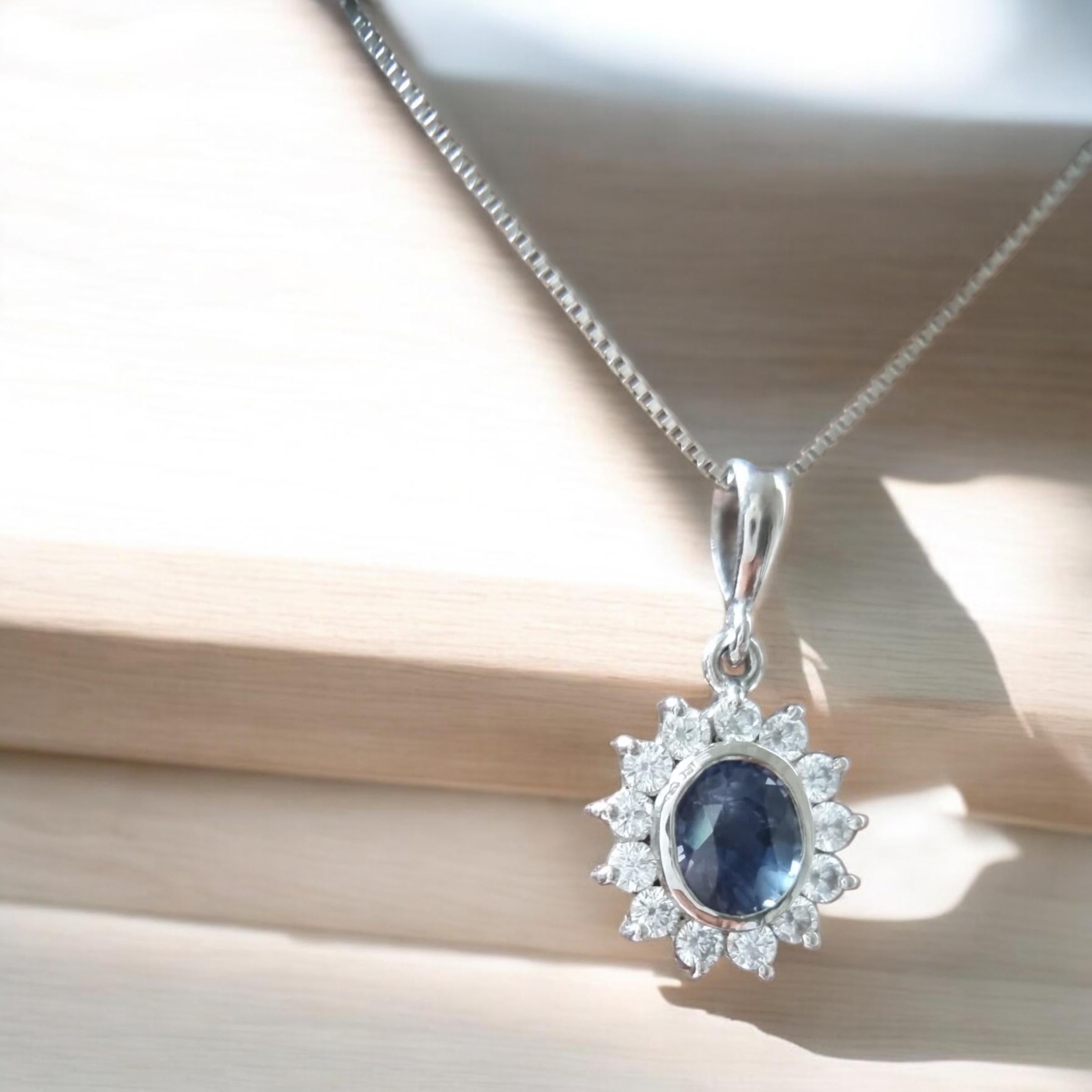 Discover the refined appeal of this Platinum-Coated Sterling Silver Blue Sapphire Necklace Pendant that measures 14.9x13.3mm. At its center sits a 9.0x7.5mm, 3.4-carat faceted blue sapphire that shifts from bright azure to deep indigo under