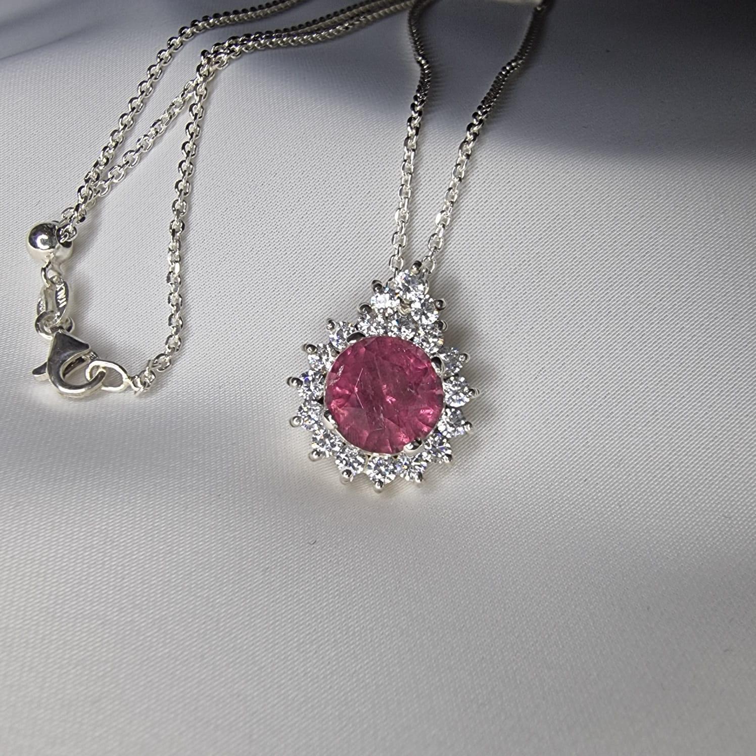 Introducing our exquisite 3ct Round Pink Natural Tourmaline Sterling Silver Pendant, a timeless piece that exudes elegance and sophistication. This stunning pendant features a captivating 3-carat round-cut pink tourmaline, known for its vibrant hue