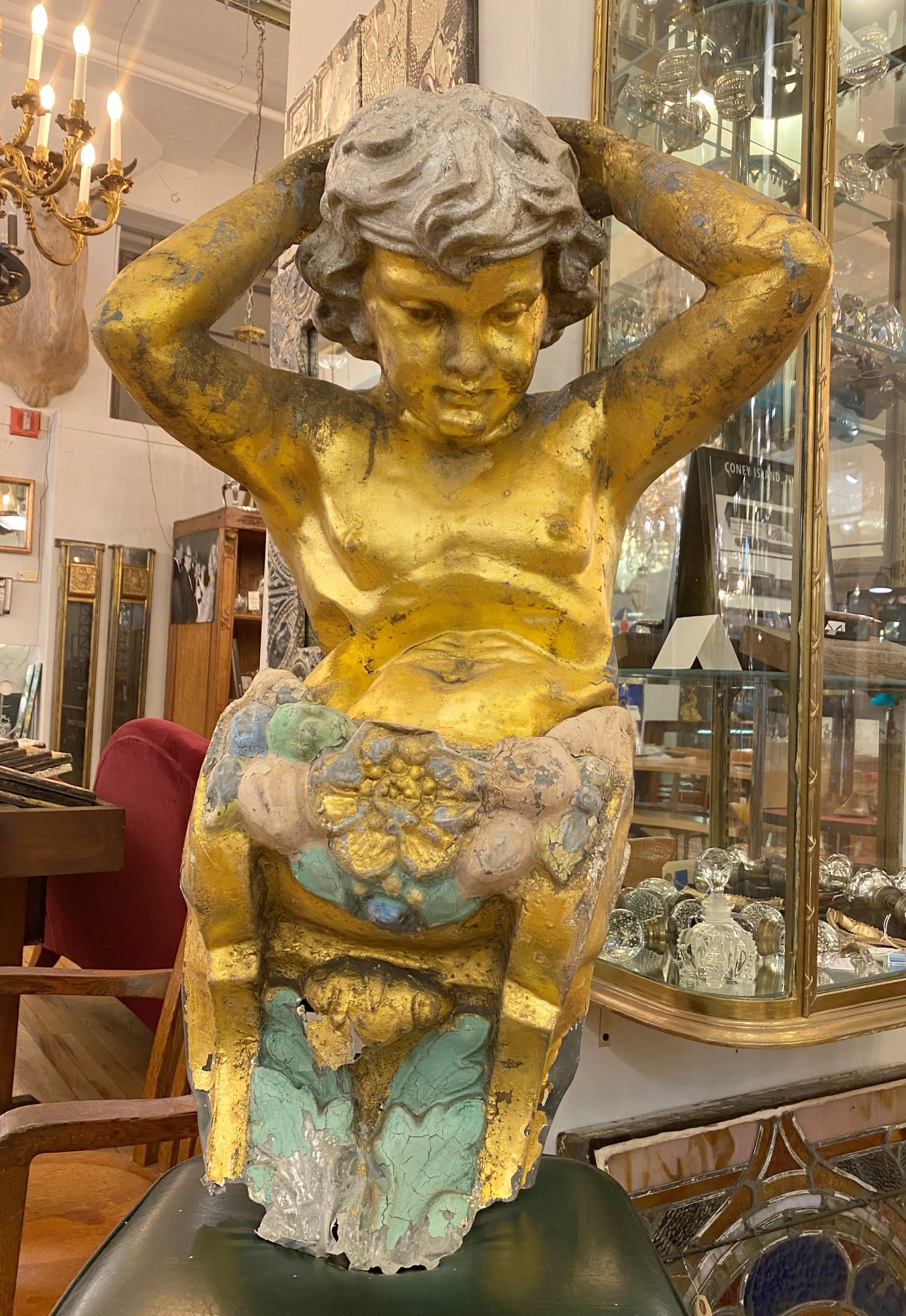 Late 19th century zinc 3 dimensional Italian putti statue of a baby angel. This piece adorned the 2nd floor building façade above the main entrance. From the Grand Prospect Hall on the Prospect Expressway in Brooklyn. Original gilt and colored