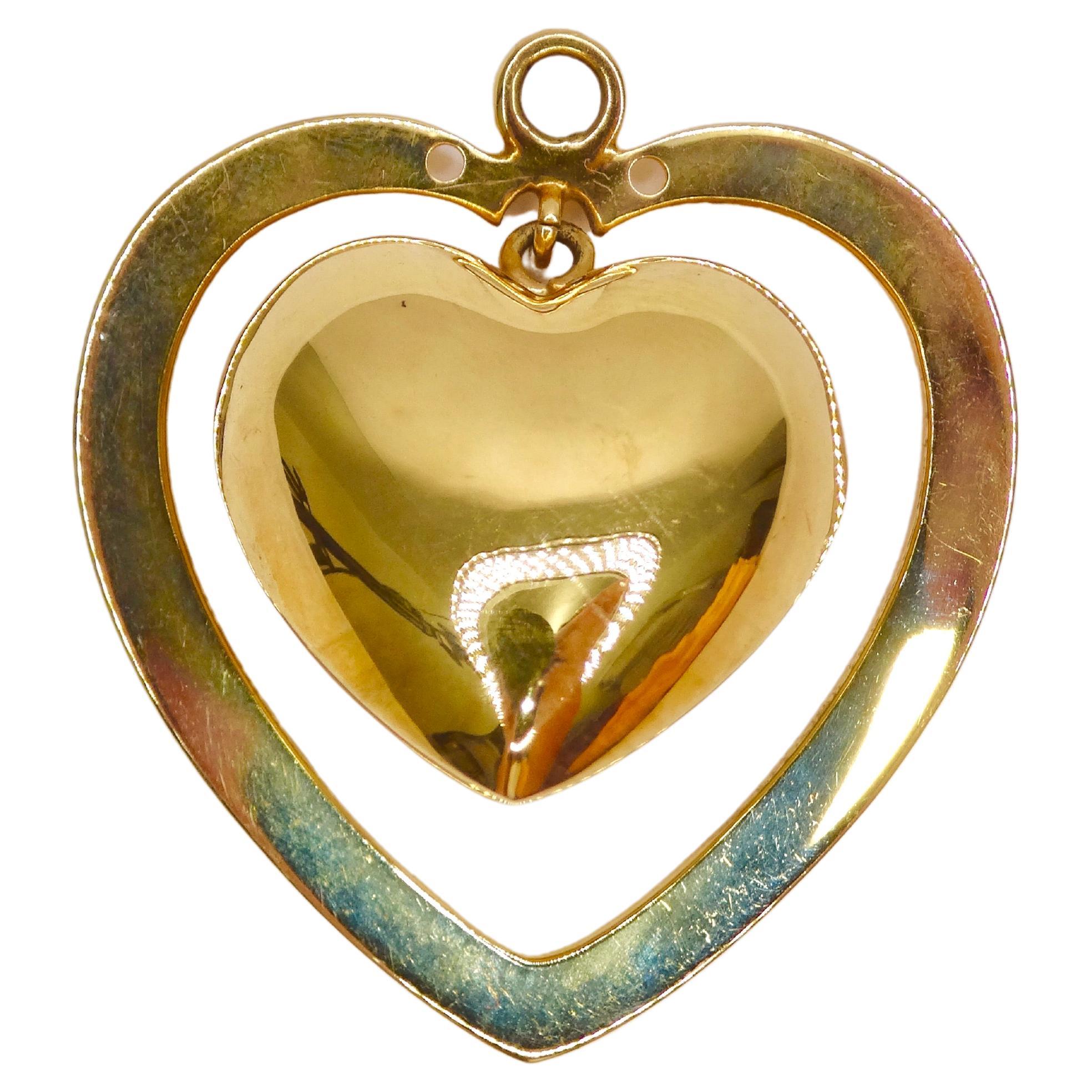 Keep your outfit fun and flirty with this 3D double-heart pendant. Details include a 3D bell heart surrounded by a larger flat heard. You won't have to wait until Valentine's day to pull off this necklace as the simple 14k Gold will match any of