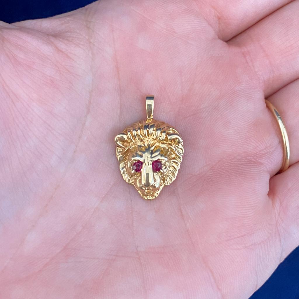 This richly detailed 14 karat gold ruby-eyed lion pendant/charm is absolutely fabulous! Lions represent strength, courage, power, leadership skills, and bravery. The lion is a sign of protection and is thought to fend off evil spirits in various