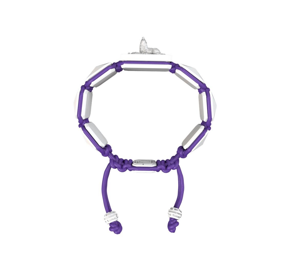 Selfmade bracelet with white ceramic and sculpture finished in White and  Platinum effect complemented with a violet coloured cord. The feeling of a selfmade person is represented by a  proud Wolf standing fierce and potent of his achivements and