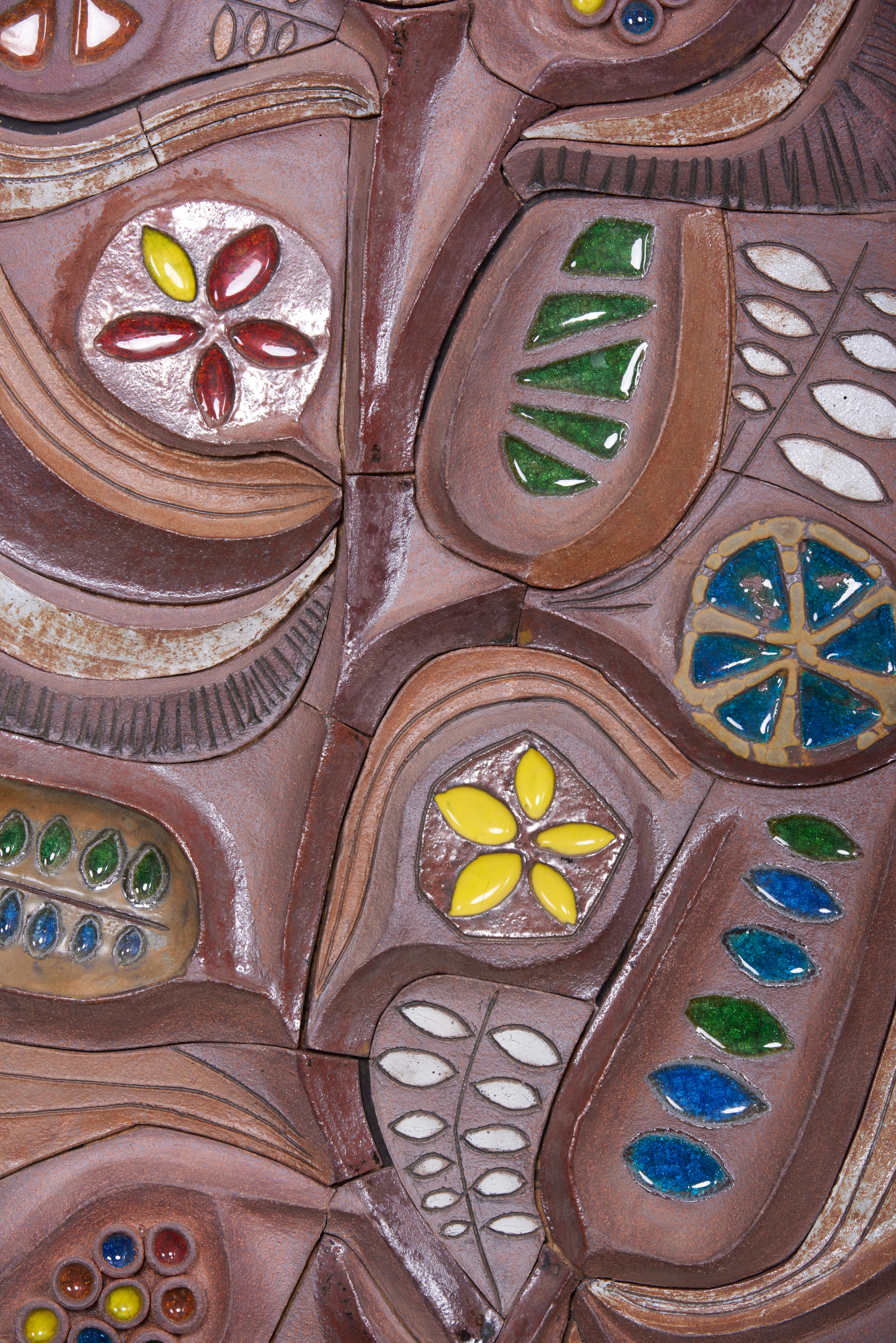 One of a kind panel with organic botanical motif.
Can be used either indoors or outdoors.
Shown in natural clay with glazes and melted glass in a steel frame.
Created 2019 by Brent J. Bennett, US (signed). Measures: 22” x 55”.

Brent J. Bennett