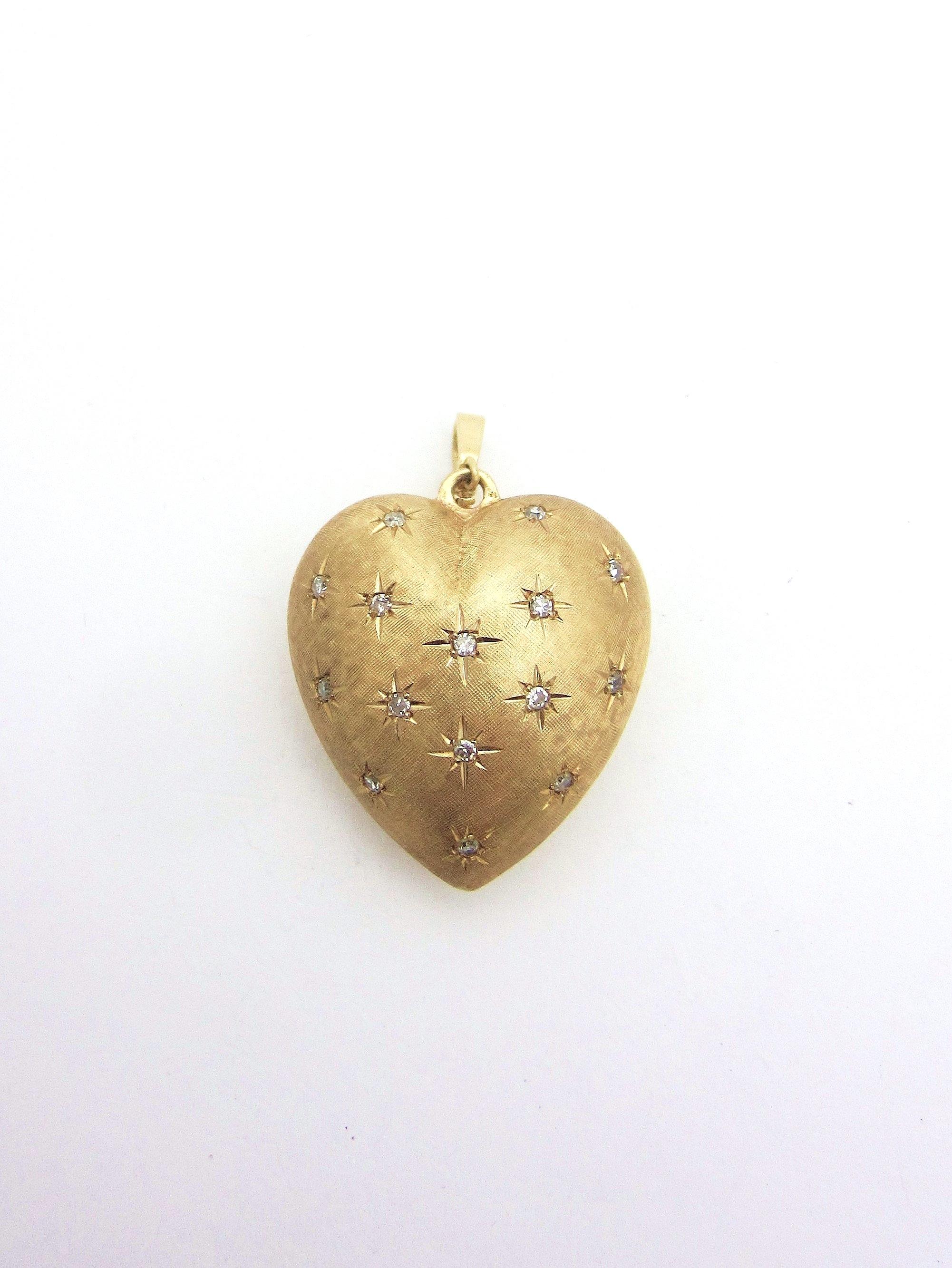 A wonderful large 14k rosy yellow gold pendant enhancer from a vintage estate in the shape of a puffed heart in 3D.  

The front contains fifteen star-set single cut diamonds weighing about .35cttw over a Florentine finished background.  The back is