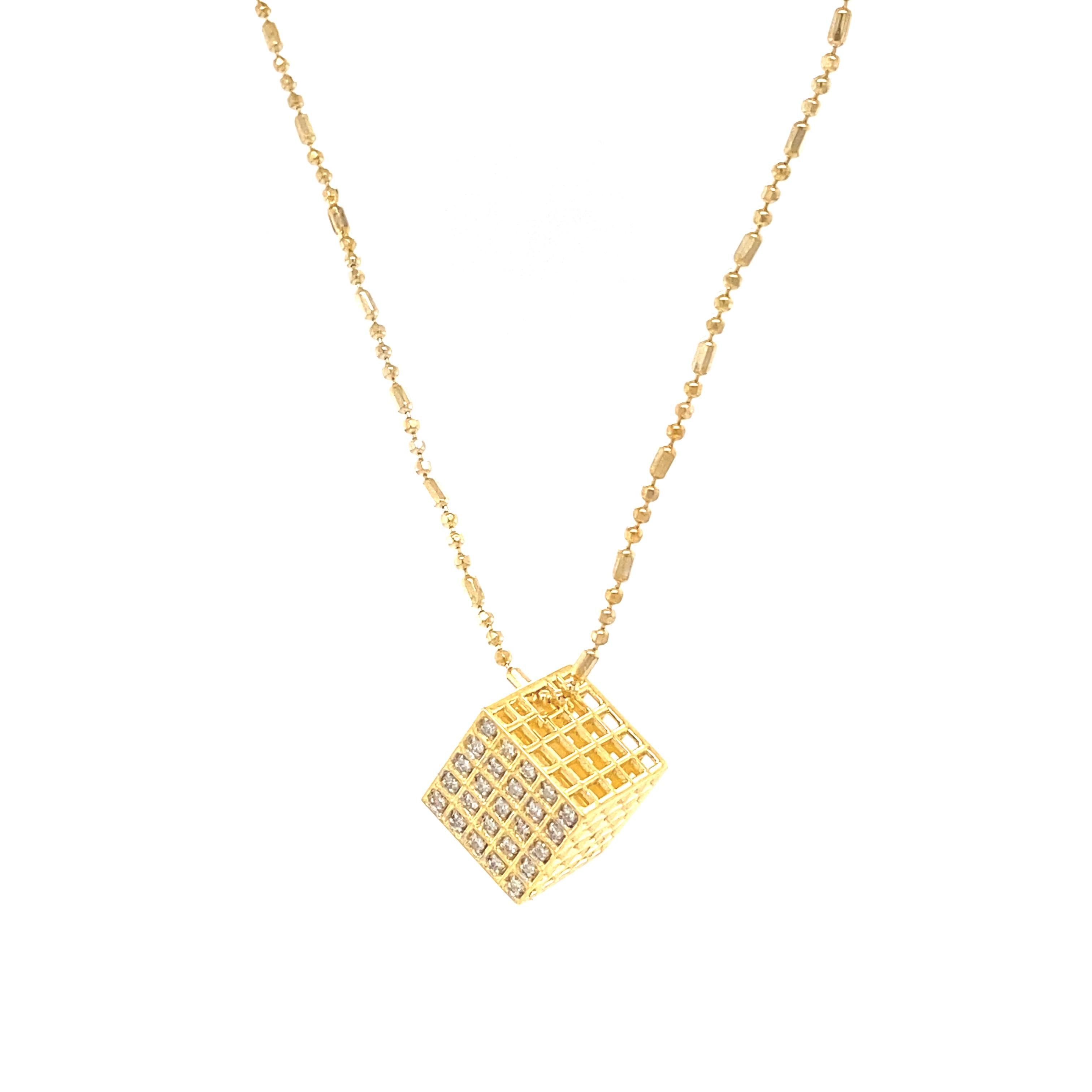 The pendant is a diamond-shaped cube design crafted in gold, adorned with multiple small, sparkling diamonds, arranged in a grid pattern that fills the one face of the cube. This piece would make a striking addition to the 1st Dibs listings,