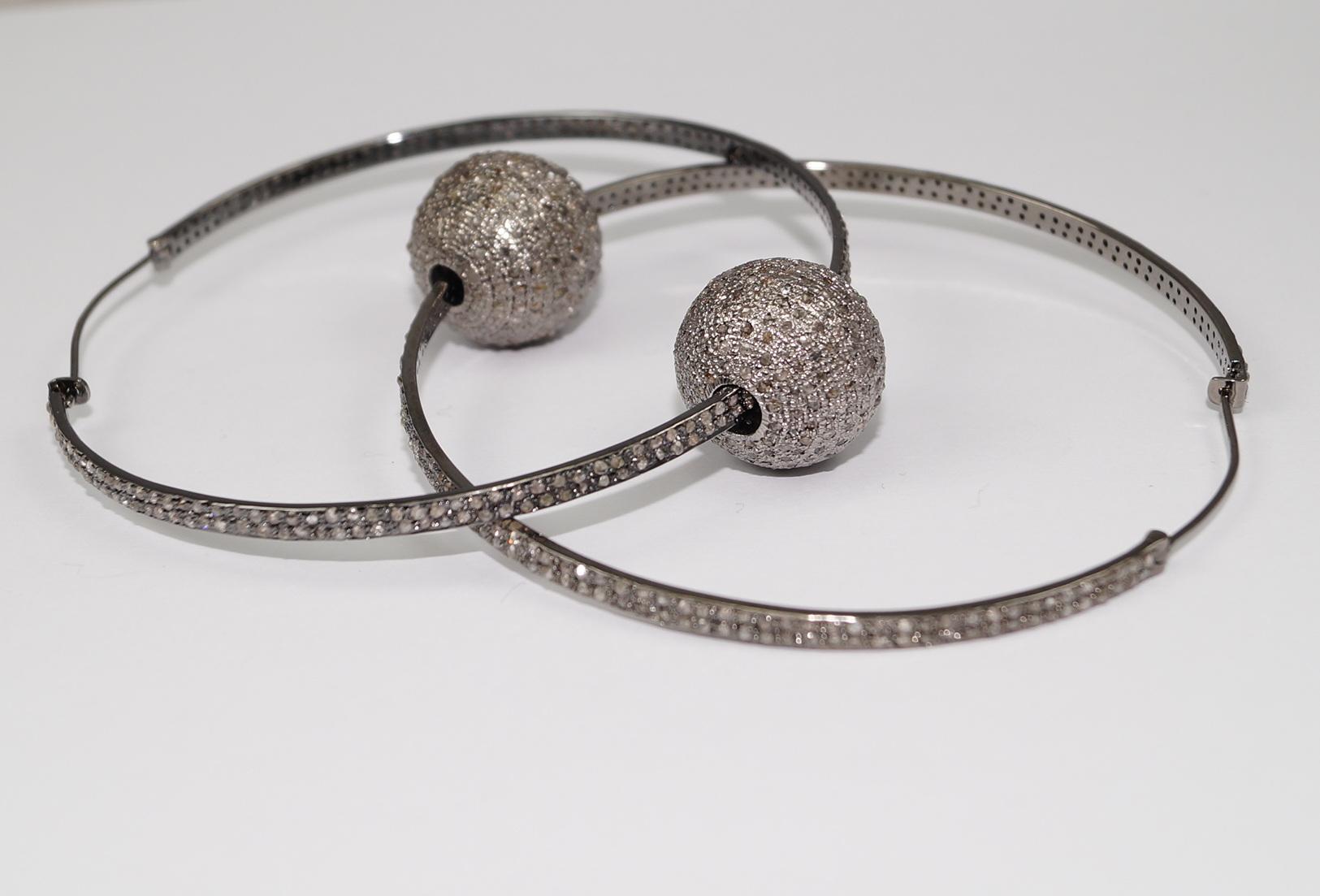 The earrings are adorned with natural pave diamonds, totaling 6.80 carats. These diamonds are sourced from the earth, ensuring their natural origin and superior quality. The pave setting enhances the sparkle and brilliance of the diamonds, creating