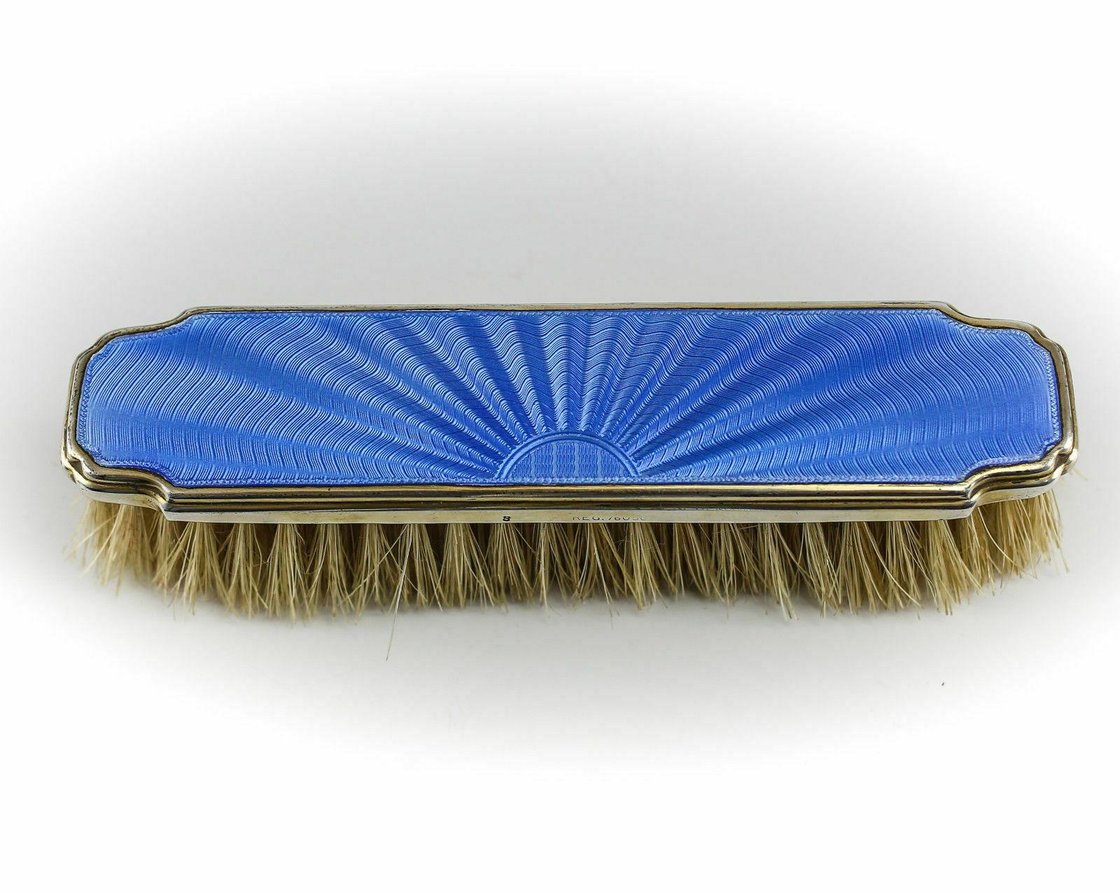 Set includes hand mirror, hair brush, & clothes brush. Beautiful hand painted aqua blue Enamel. Hallmarked for Elkington & Co.

Additional information:
Brand: Birmingham 
Composition: Sterling silver
Dimension: Mirror 10.5 inches Length; Hair