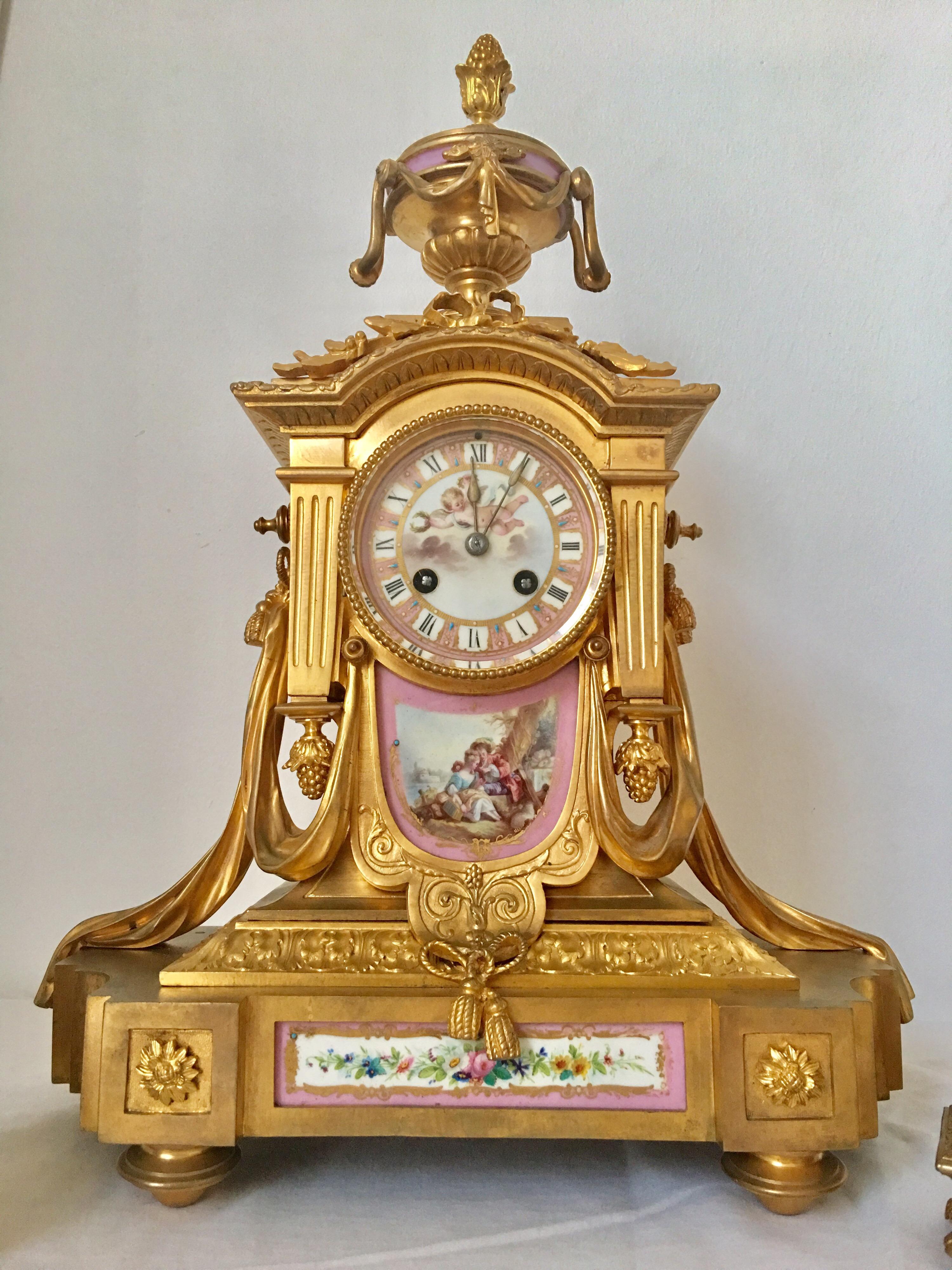 This stunning 3 pcs. Set pink porcelain & ormolu French clock signed by Japy Freres & Co. and retailed by Howell James & Co. To the Queen is working and ticking well. It strikes every hour and half an hour on a bell, circa 1860.