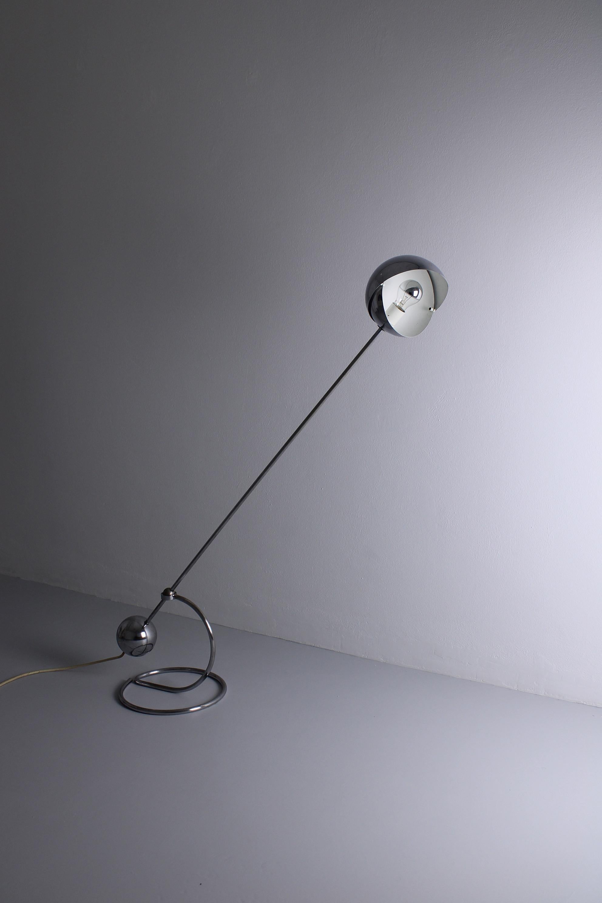 Floor lamp model S3 was designed by Paolo Tilche for Sirrah, Italy, in 1961. This piece has a round counterweight that creates the perfect balance to adjust it. The round shade is adjustable and creates a very nice spherical light when changed in