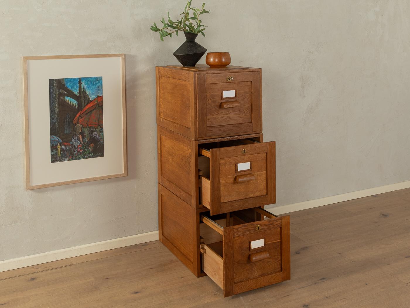 Classic file cabinet from the 1920s. Solid three-part oakwood corpus with each one drawer, The single parts can be combined or placed separately.

Quality Features:
very good workmanship
high-quality materials
solid wood drawers
Made in
