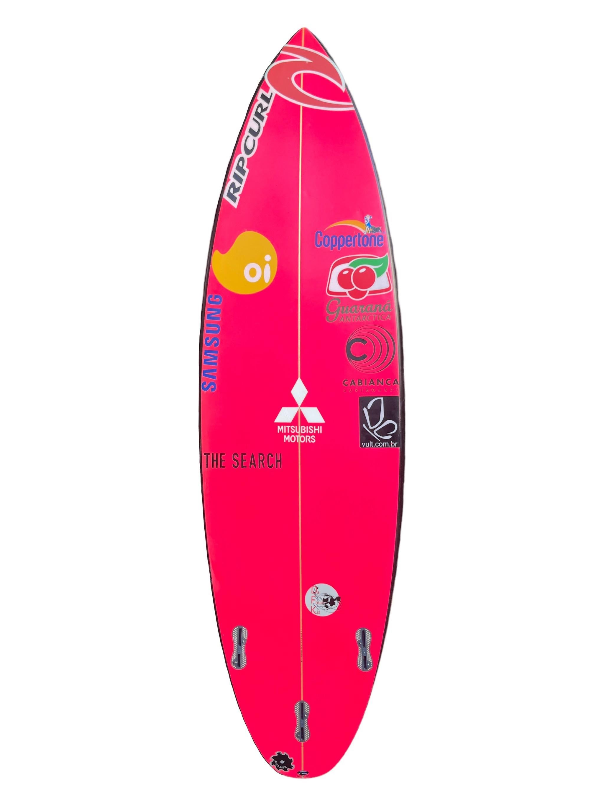 3X World Champion, Gabriel Medina’s personal surfboard. Medina is the 2014/2018/2021 WSL World Champion of Surfing. Image of Gabriel Medina performing an aerial maneuver on a similar surfboard taped to the nose. Ride or display this prized world