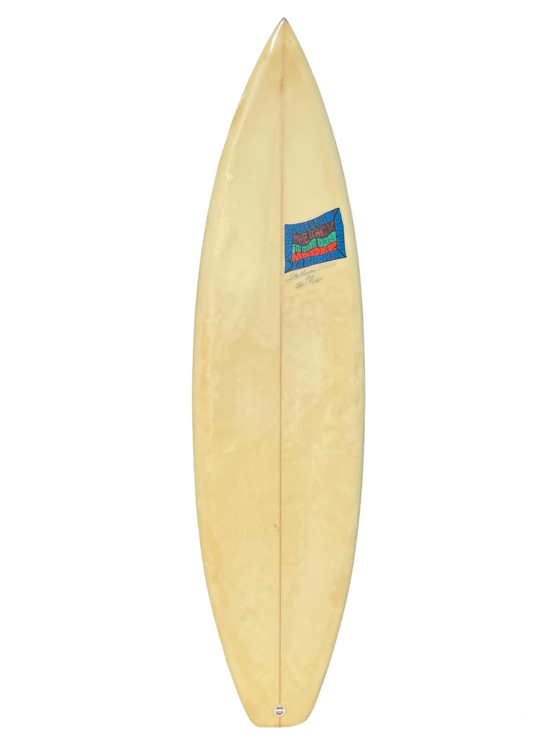 1990s Vintage Joel Tudor personal surfboard shaped by Stu Kenson. Features colorful confetti art design with hand painted logo by Joel Tudor. Glassed on thruster (tri-fin) setup with squash tail. Joel Tudor is currently a 3X Longboard World Champion