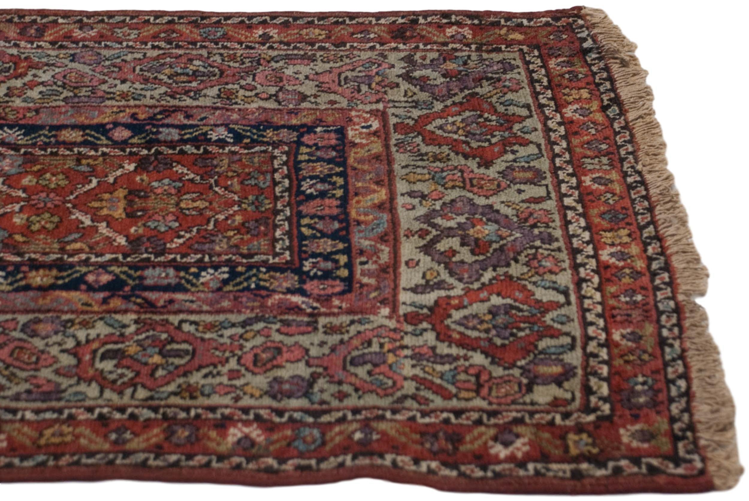 :: Highly unusual and early example of a Fereghan carpet, in unreduced original proportions with narrow framed main field in lattice paneled diamond shaped outline with each interior fill of tree of life motif, and wide banded main border with
