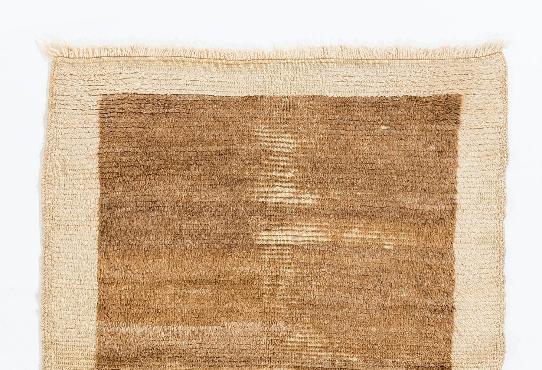 A vintage hand-knotted Tulu (Turkish word for thick-piled) rug from Konya in Central Anatolia, Turkey. Made of 100% un-dyed natural hand-spun sheep's wool in beige and brown with lovely color striation in places. Measures: 3 x 4 ft.

These simple,