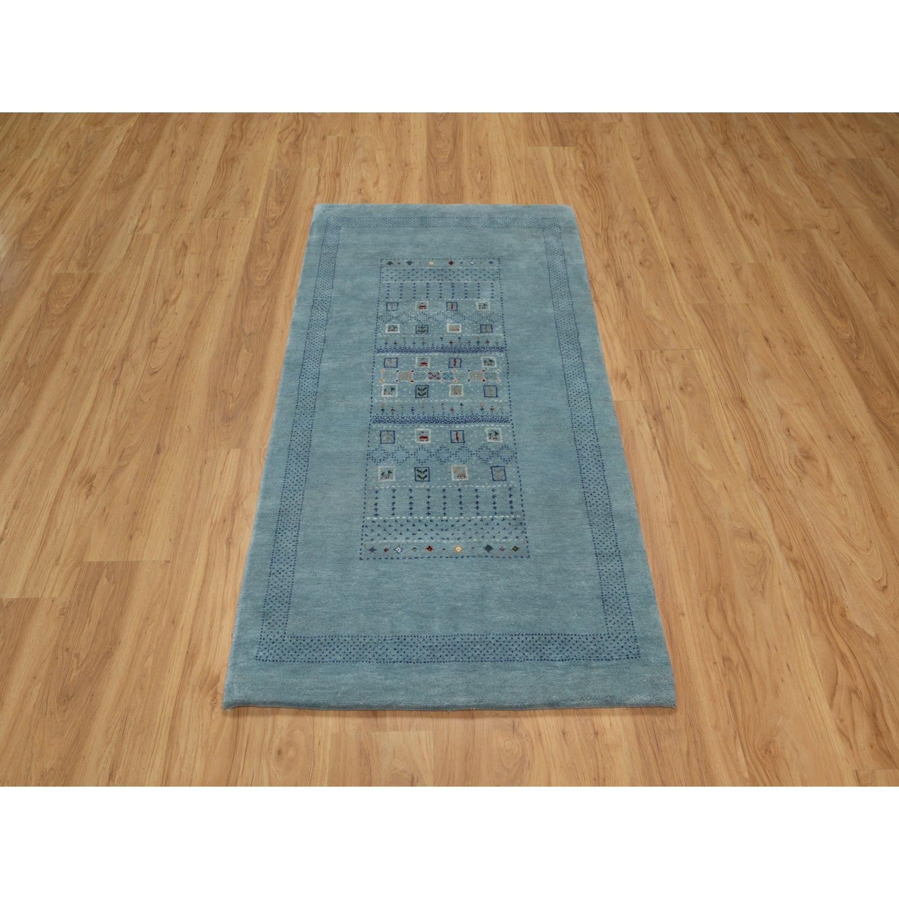 Stone Blue, Lori Buft Gabbeh with Small Animal Figurines, Modern, Thick and Plush, 100% Wool, Hand Knotted, Oriental Rug
Primary materials: Wool
Latex: No Pile 
height: 0.25 Inches
Style: Contemporary
Primary color: Blue
Secondary colors: Red, Gray,