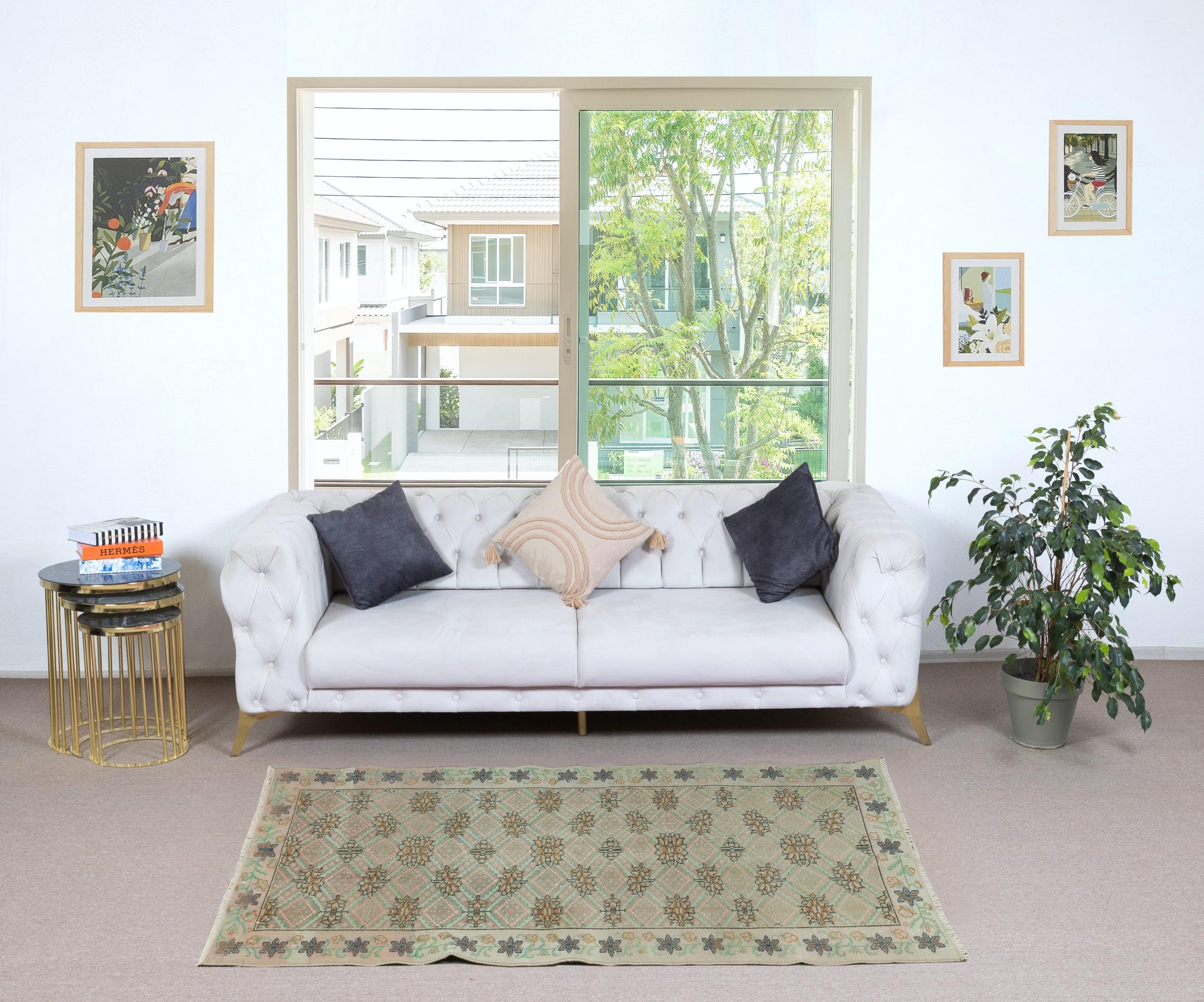 Infuse your home with the timeless beauty of this traditional vintage handmade Turkish rug, a hand-knotted masterpiece crafted from a luxurious blend of wool and cotton. Woven by skilled artisans using centuries-old techniques, this rug features