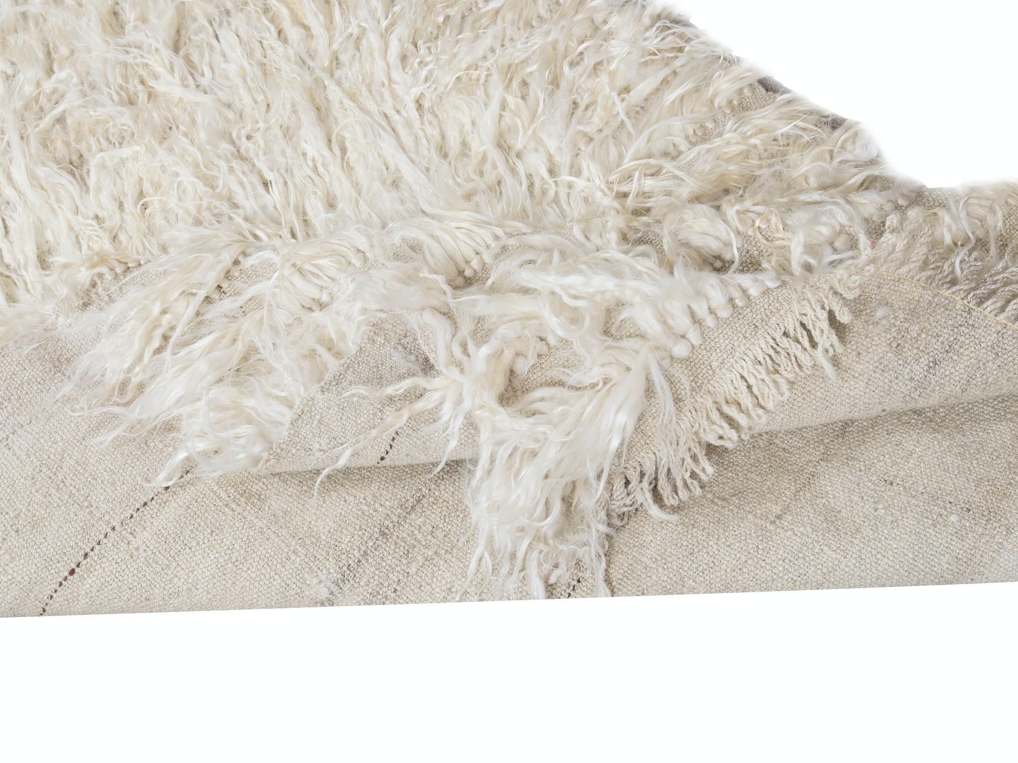 A vintage hand-knotted shag pile runner rug made of natural undyed mohair derived from local “Angora Goats” that are famous for their soft, lustrous long fleece. A true testament to Anatolian craftsmanship, this rug brings together the softness of