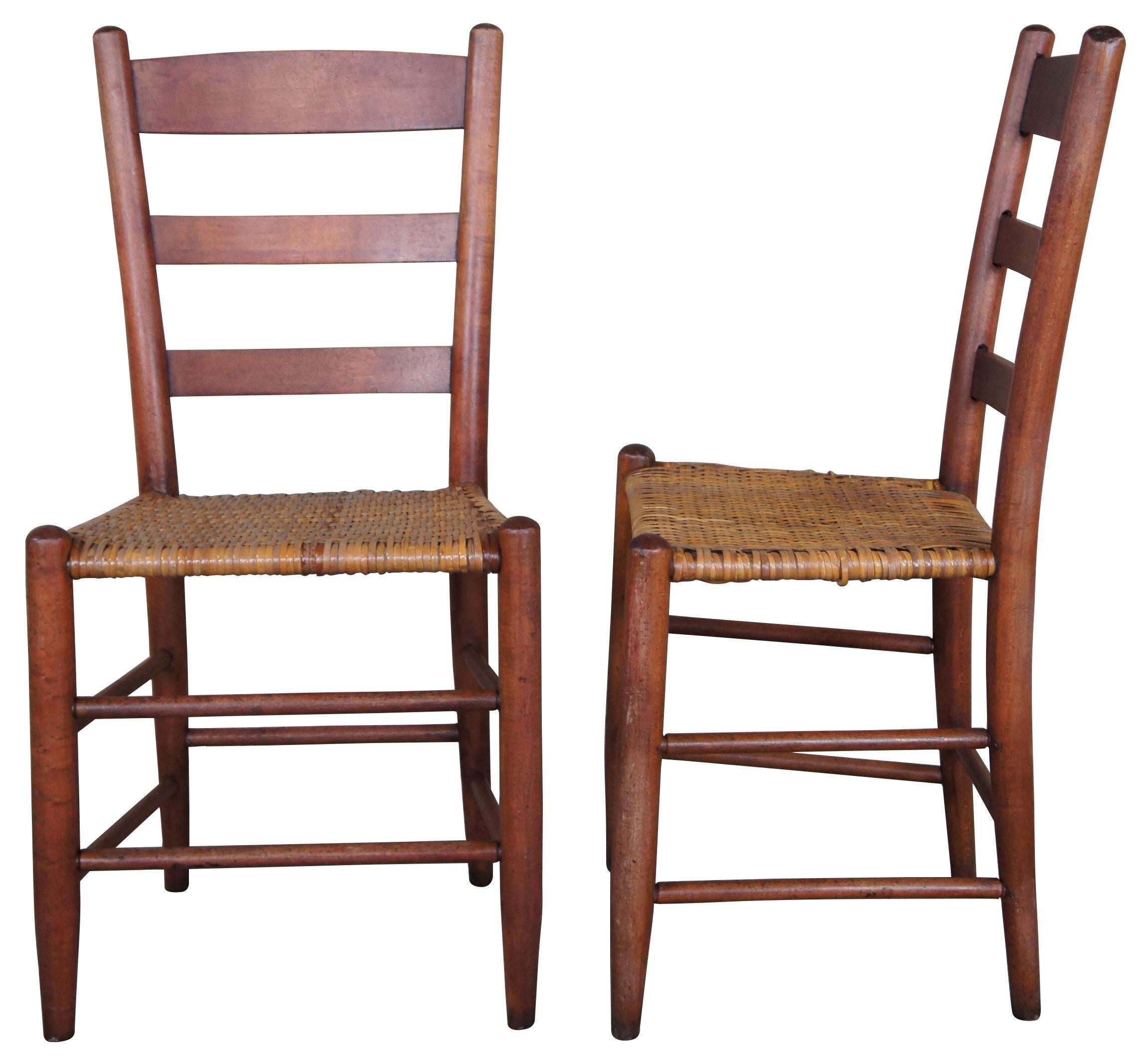 4 solid maple shaker dining chairs. Feature a ladderback and reed woven seats. 
     