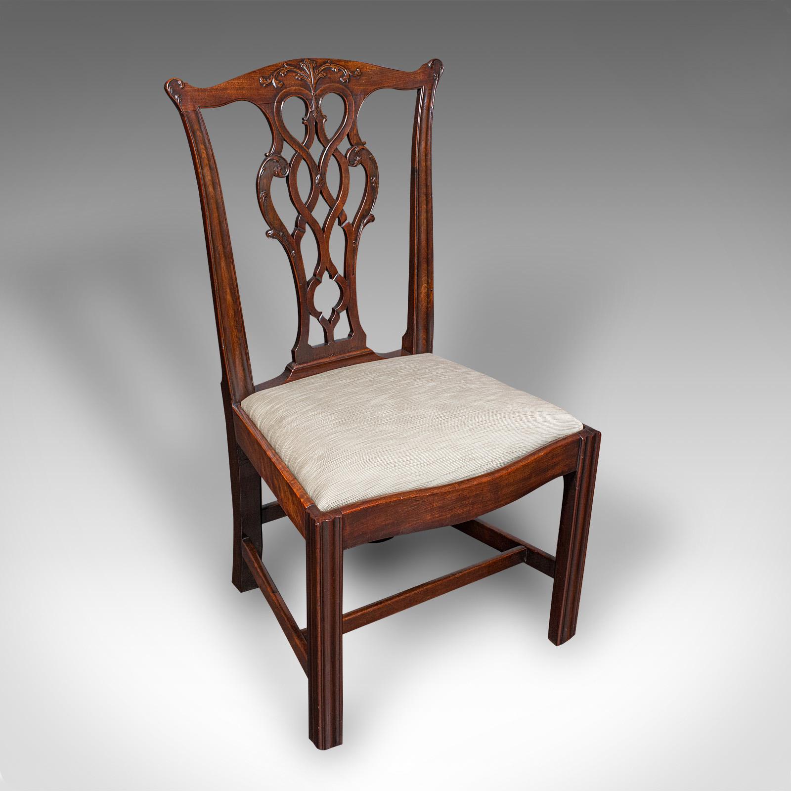 This is a set of four antique dining room chairs. An English, mahogany seat in the Chippendale manner, dating to the Georgian period, circa 1800.

Superb Chippendale revival chairs, with appealing upholstery and generous width
Displaying a desirable