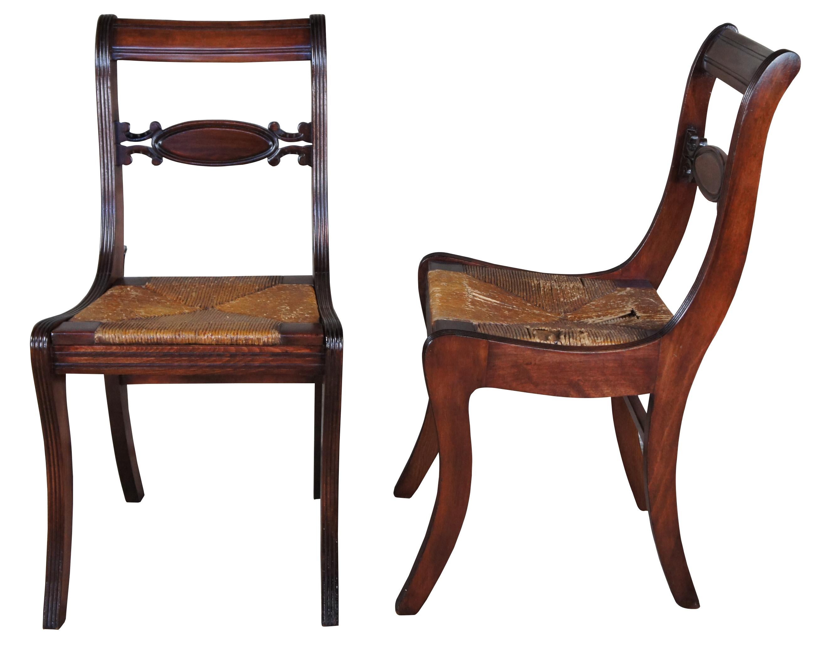 4 early 20th century Duncan Phyfe or Englsih Regency style dining chairs. Features fluted stiles and caned seats.
 