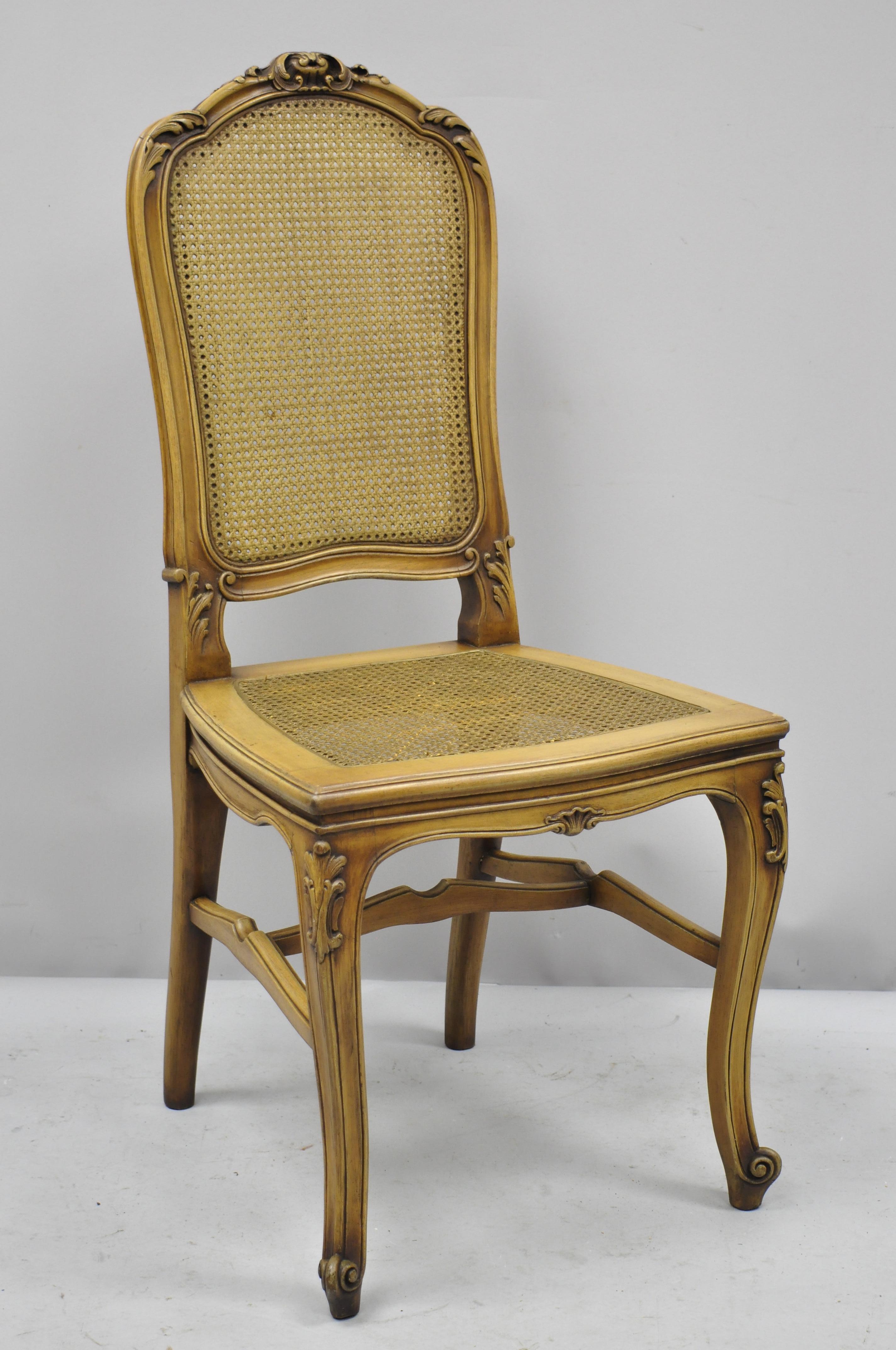 4 antique French Provincial Louis XV style carved walnut and cane dining chairs. Listing features cane back and seat, carved stretcher, solid wood construction, beautiful wood grain, finely carved details, cabriole legs, very nice antique item,