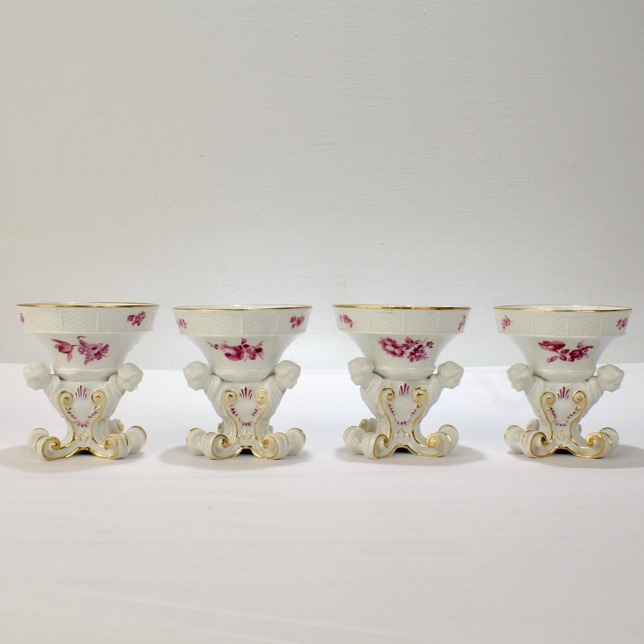 A very fine set of 4 antique Meissen porcelain salt cellars.

Modelled after salts originally designed for the Sulkowski service by Johann Friedrich Eberlein (1696-1749). 

Having a tapered, circular bowl with basketweave border, painted with