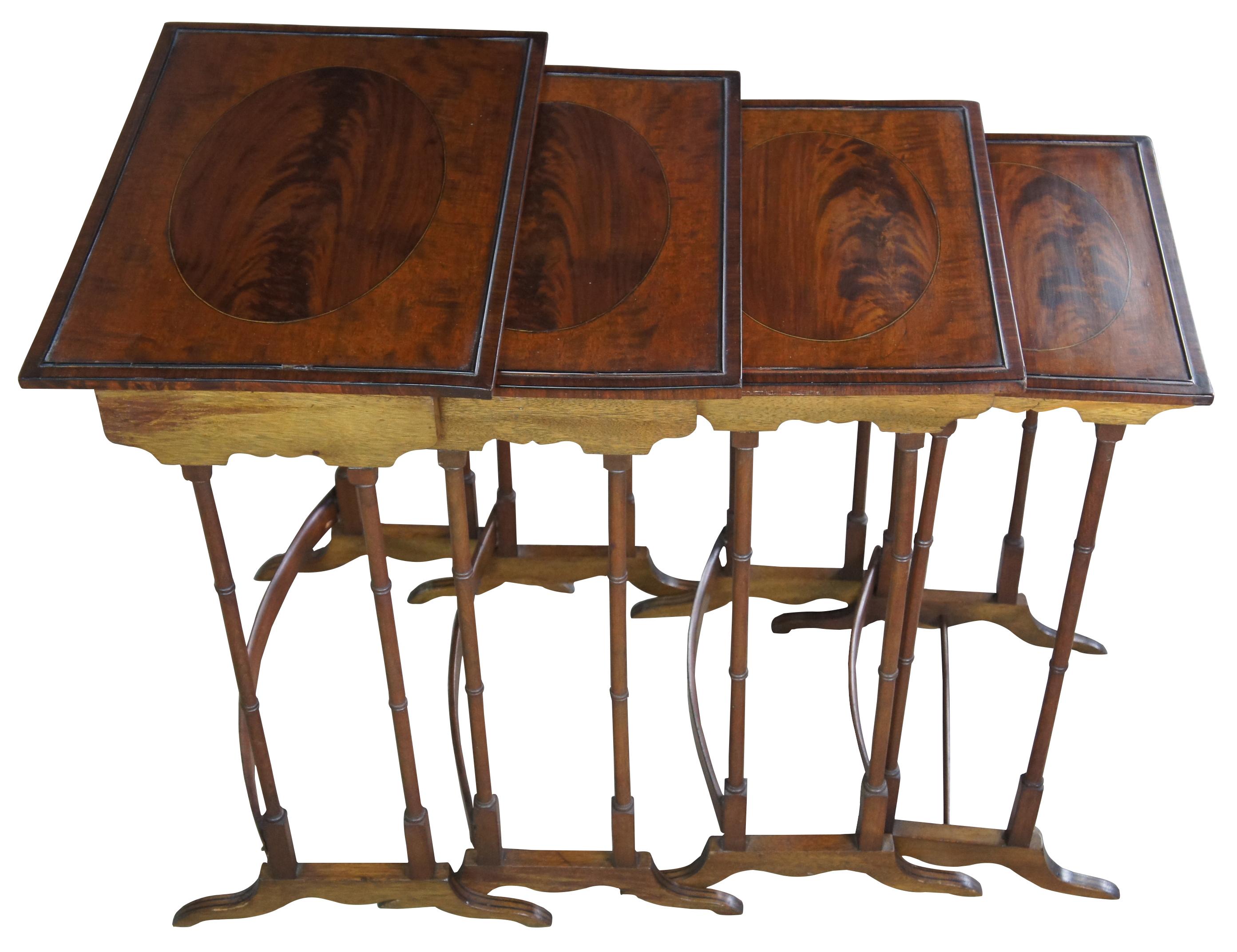 Nest of four antique Regency side or accent tables. Made of flamed mahogany featuring rectangular form with inlaid oval top, bamboo style legs, bentwood stretcher and serpentine feet.

Measures: largest 13.75