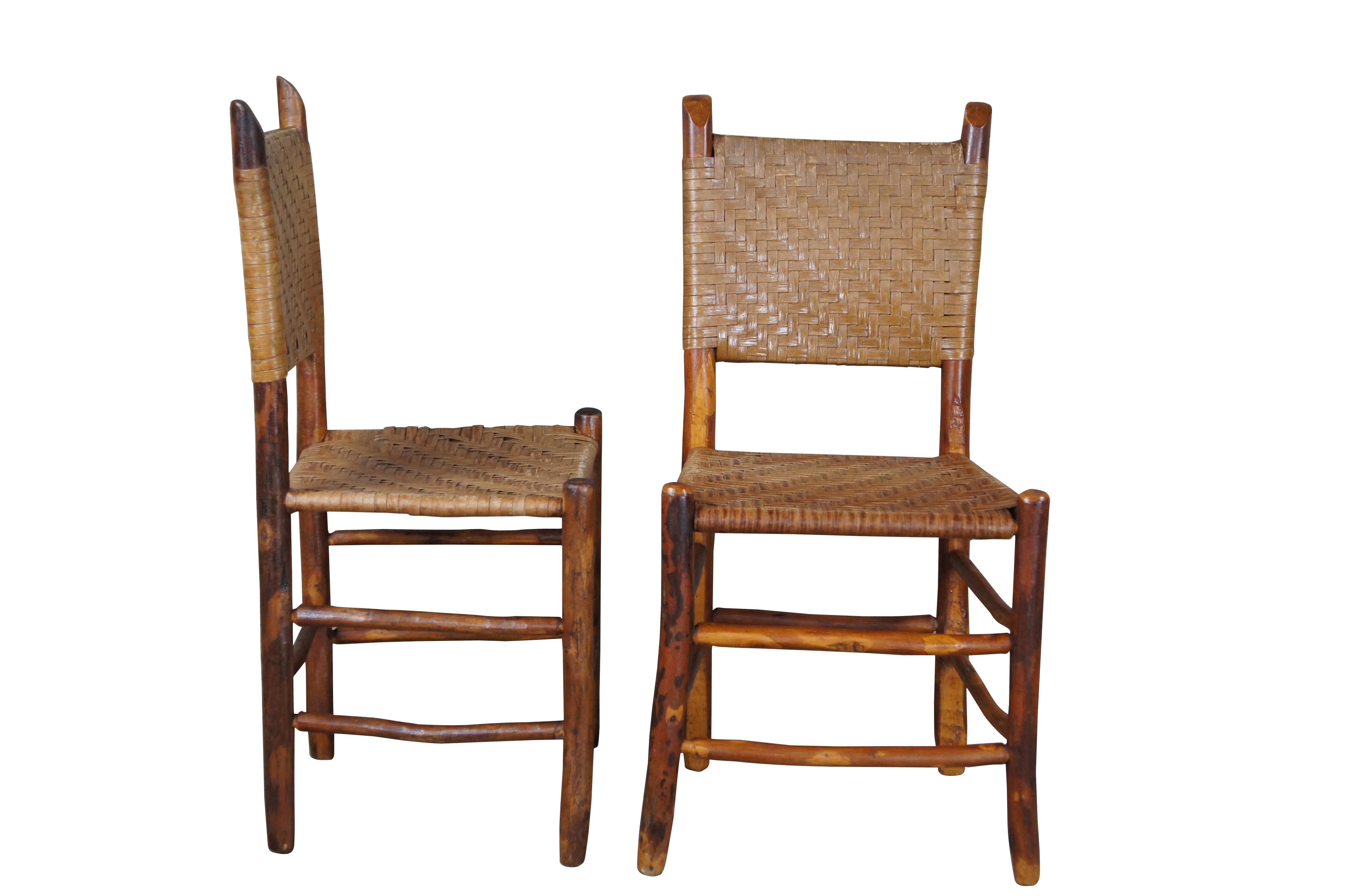 Set of four antique Adirondak / lodge / cabin / farmhouse dining chairs.  Made of Hickory featuring woven rattan seats and backs with primitive log / stick frames.

Dimensions:
17.5