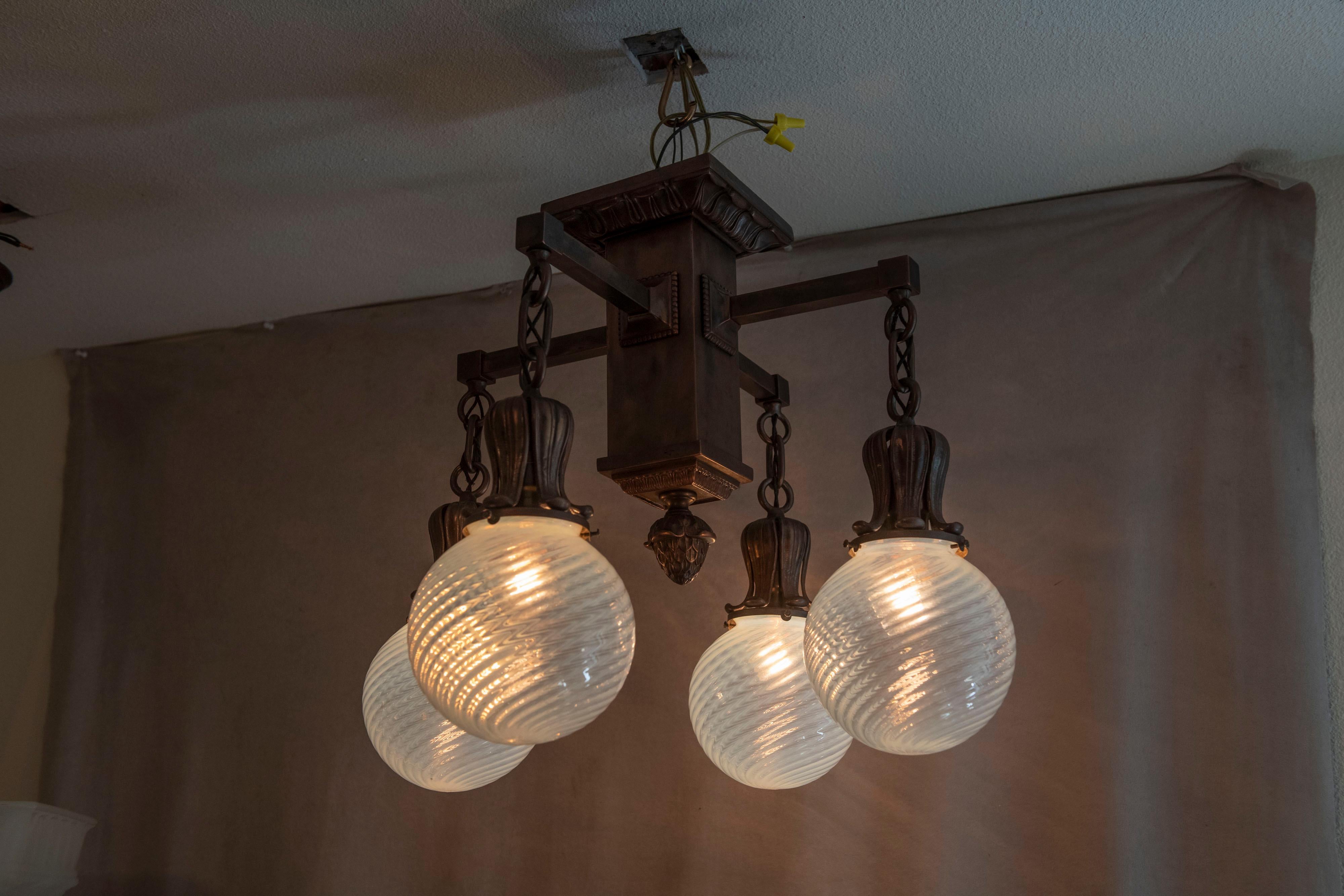 If you need a beautiful chandelier with ceiling limitations, check this one out. It''s all beautiful. A bronze flush mount chandelier with a nice finish, and crisp casting, coupled with 4 hand blown stunning opalescent swirl globes.
 Certainly one