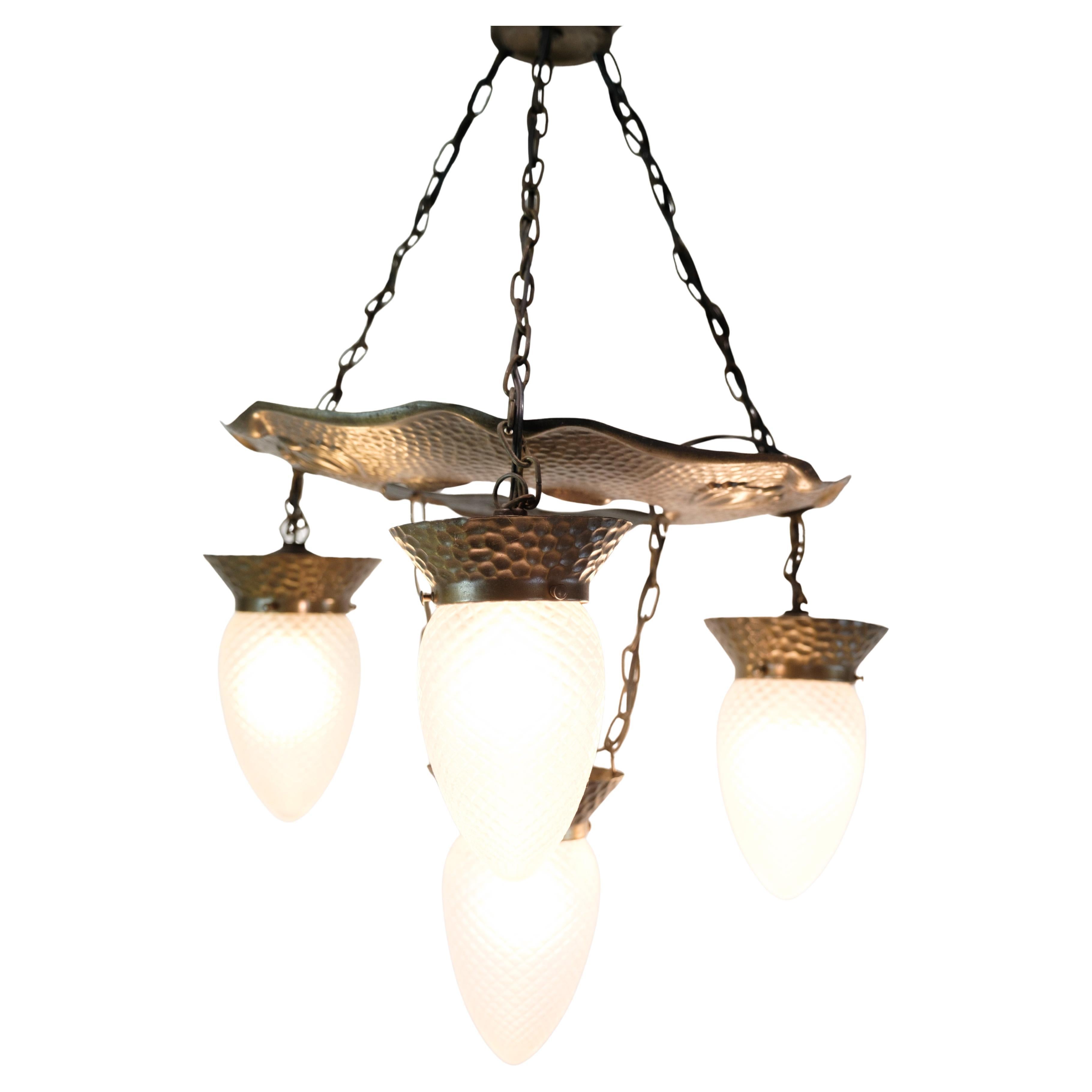 4 Armed Art Nouveau Chandelier In Patinated Hammered Brass & Teardrop Glass For Sale
