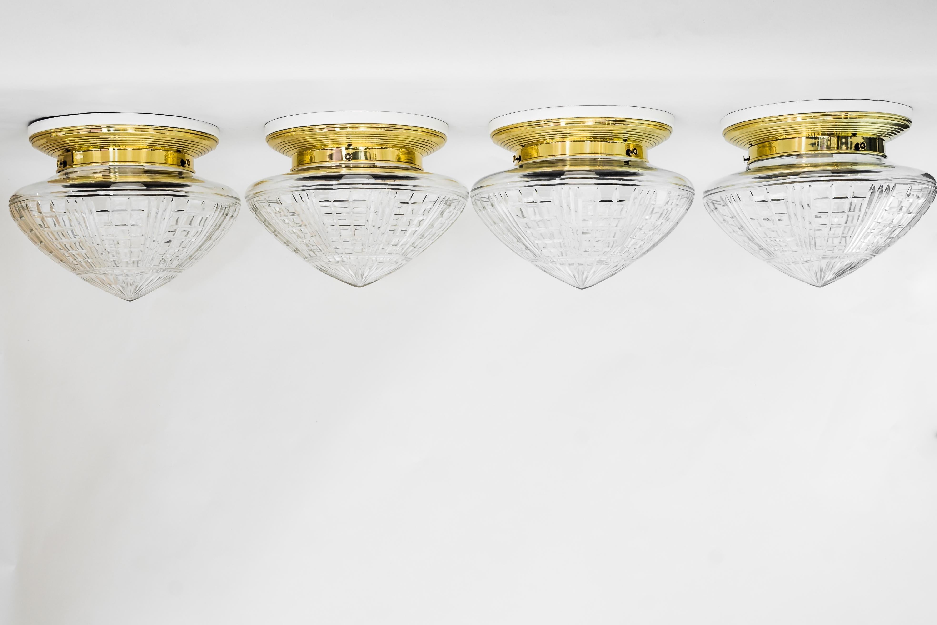 4 Art Deco ceiling lamps, Vienna, around 1920s (price per piece)
Brass polished and stove enameled
Original cut glass
Original wood plates on top white painted).