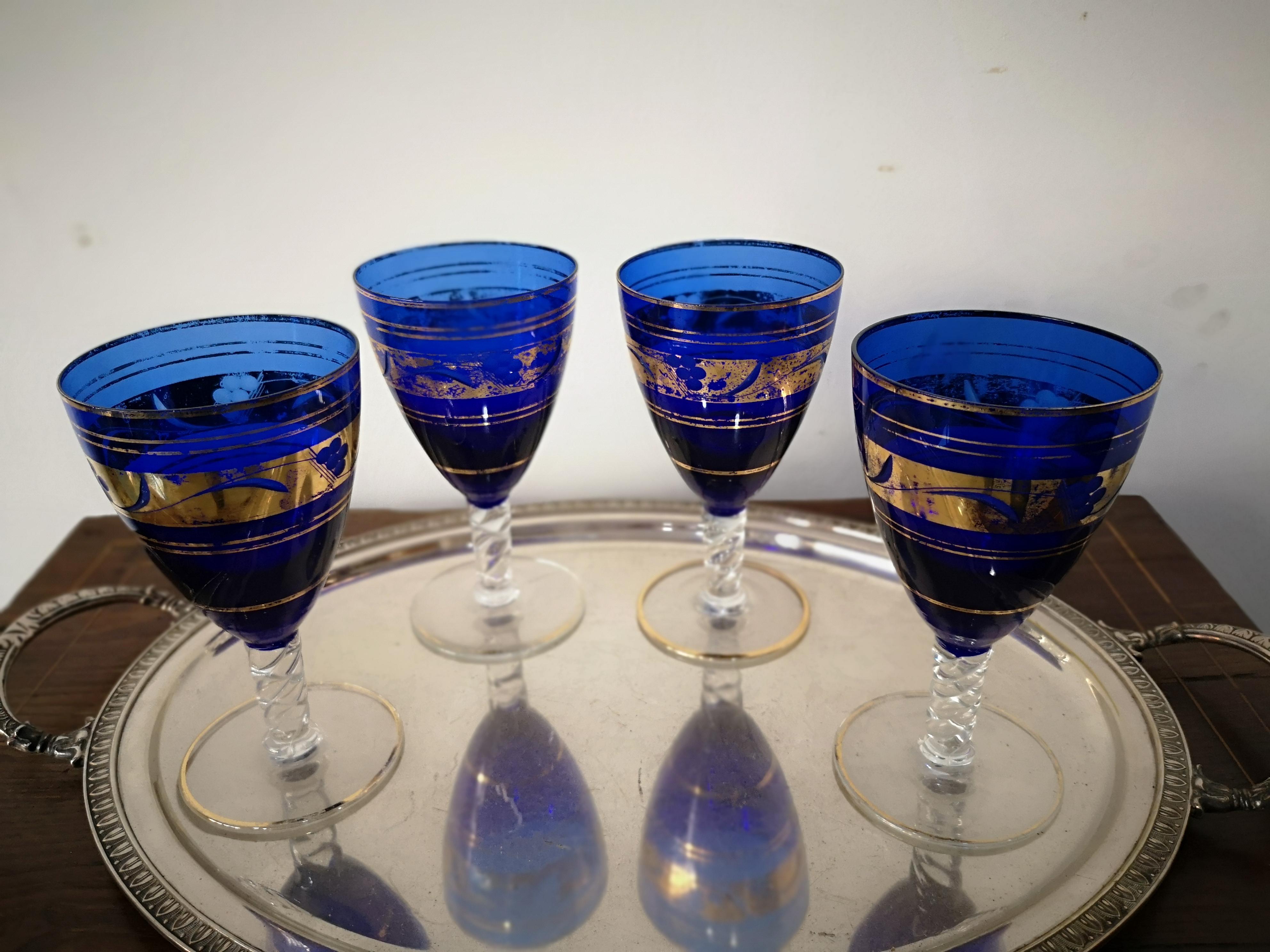 Murano glass drinking glass service with cobalt blue carafe and pure gold trim, mid-19th century. In very good condition consistent with the wear and tear of time. The pitcher is 26 cm high and top width 16 cm. The glasses are 16 cm high and 9 cm